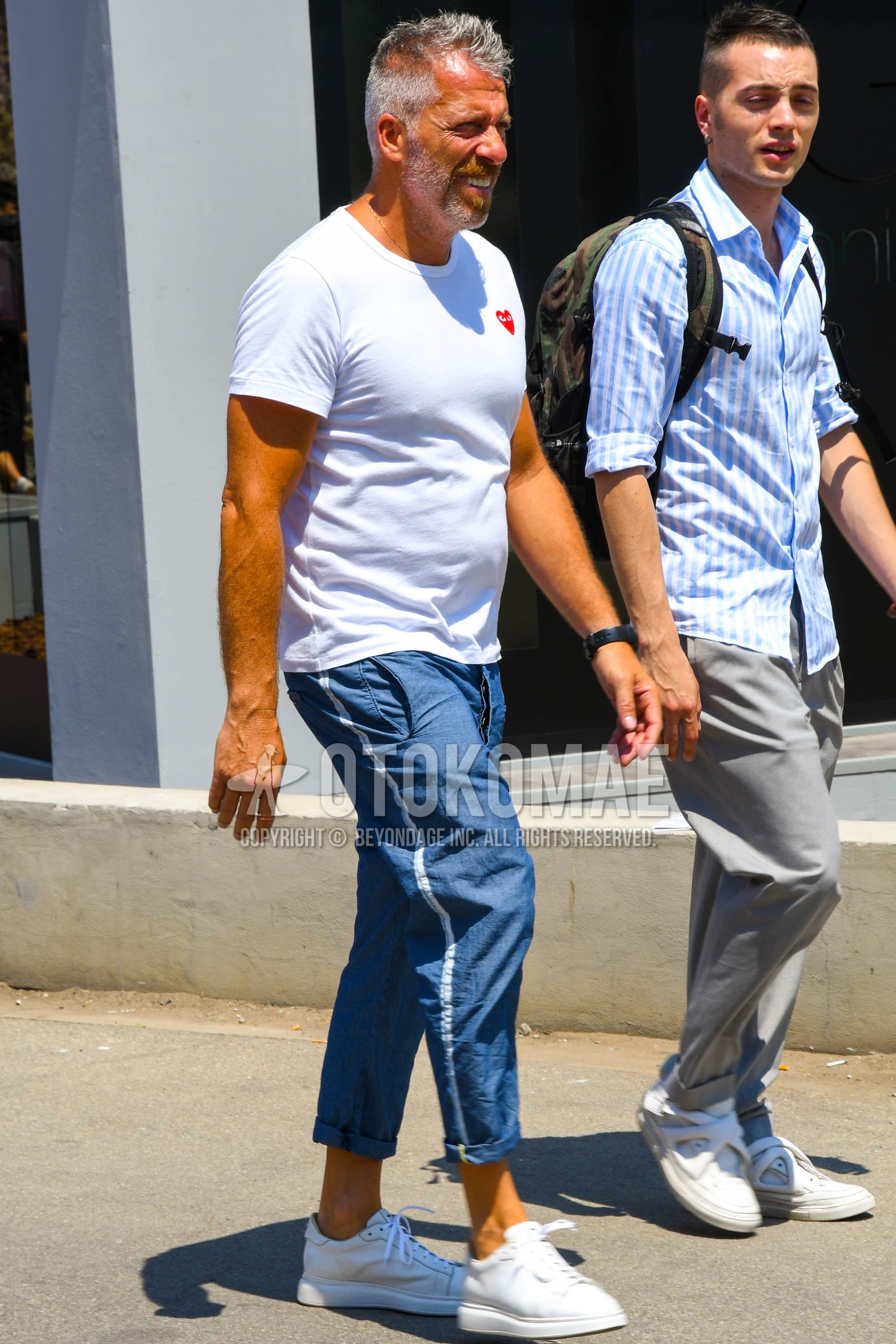 Men's summer outfit with white one point t-shirt, blue plain sideline pants, white low-cut sneakers.