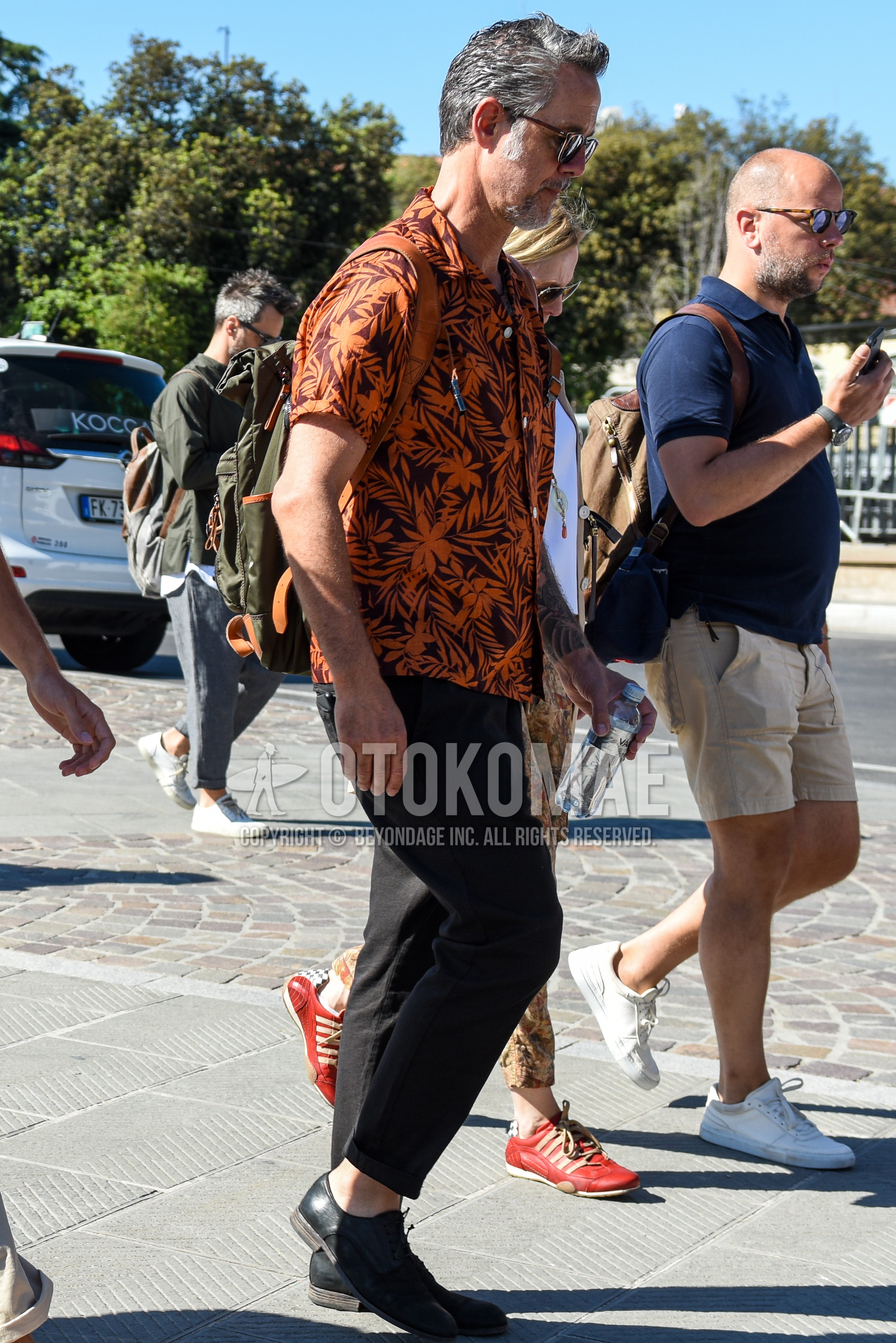 Men's summer outfit with brown tortoiseshell sunglasses, orange tops/innerwear shirt, black plain denim/jeans, black plain toe leather shoes.