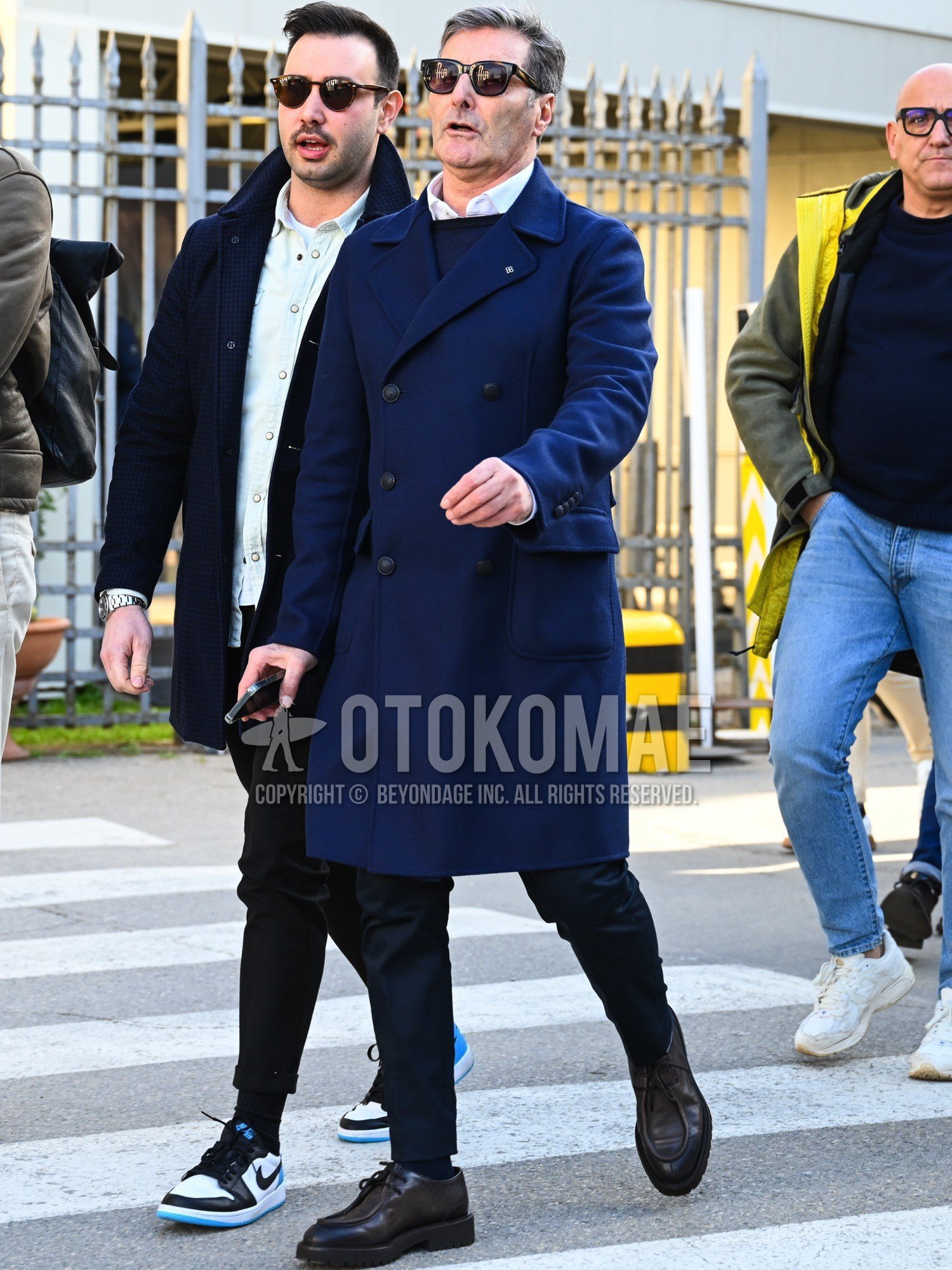 Men's autumn winter outfit with black eyewear sunglasses, navy plain ulster coat, white plain shirt, navy plain sweater, navy plain slacks, black plain socks, brown u-tip shoes leather shoes.