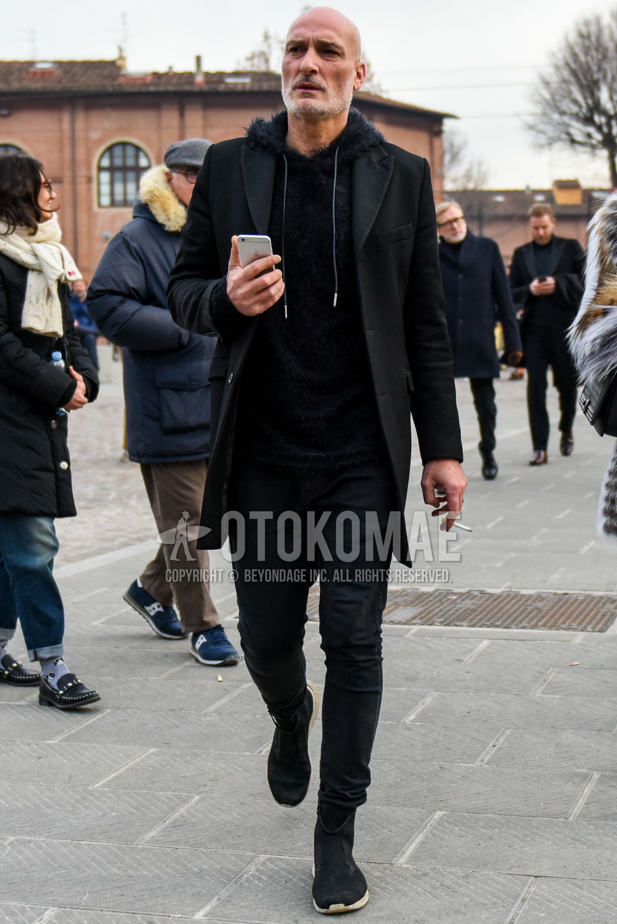 Men's spring autumn outfit with black plain chester coat, black plain hoodie, black plain denim/jeans, black high-cut sneakers.