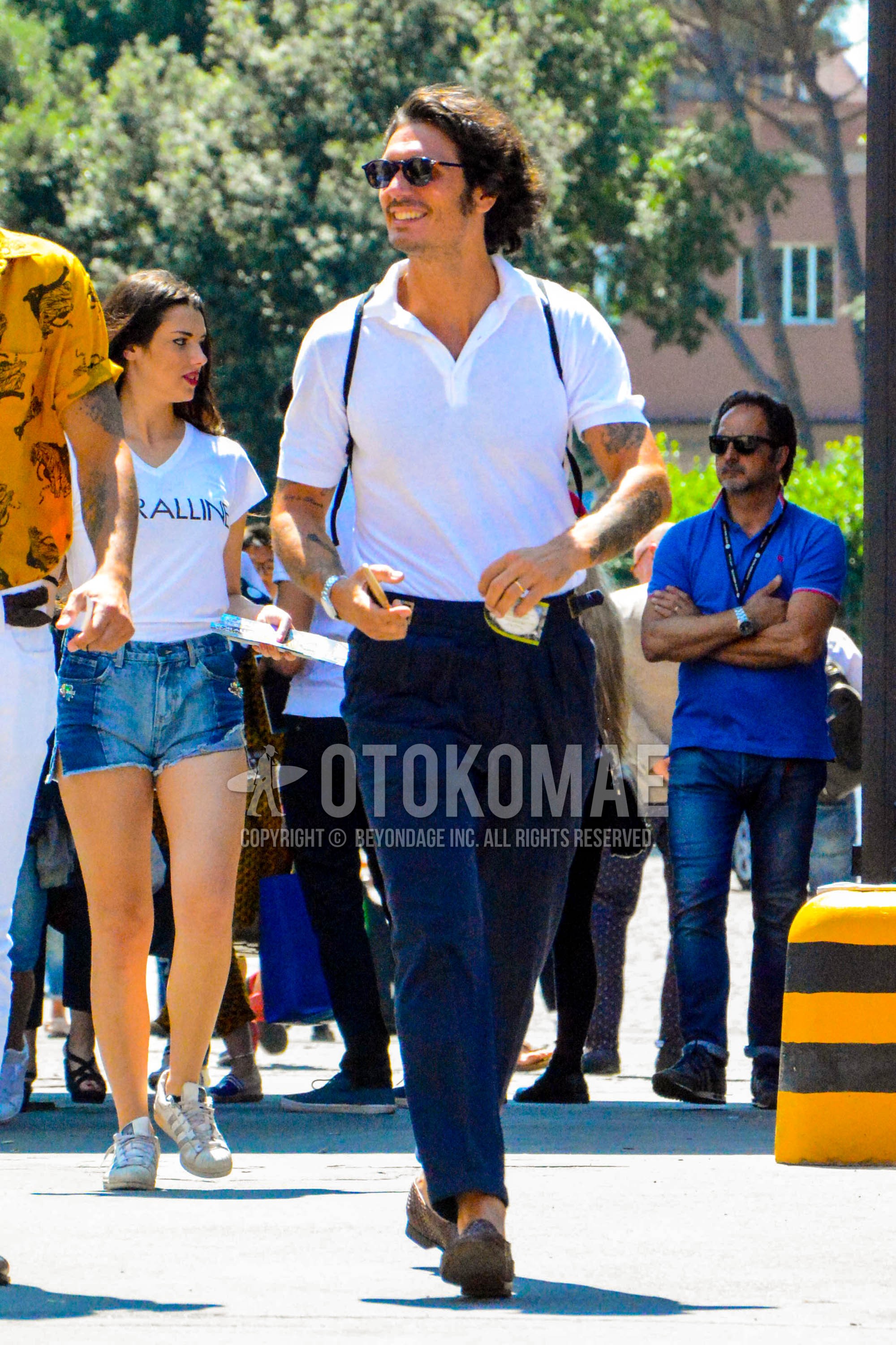 Men's summer outfit with plain sunglasses, white plain polo shirt, navy plain beltless pants, plain ankle pants.