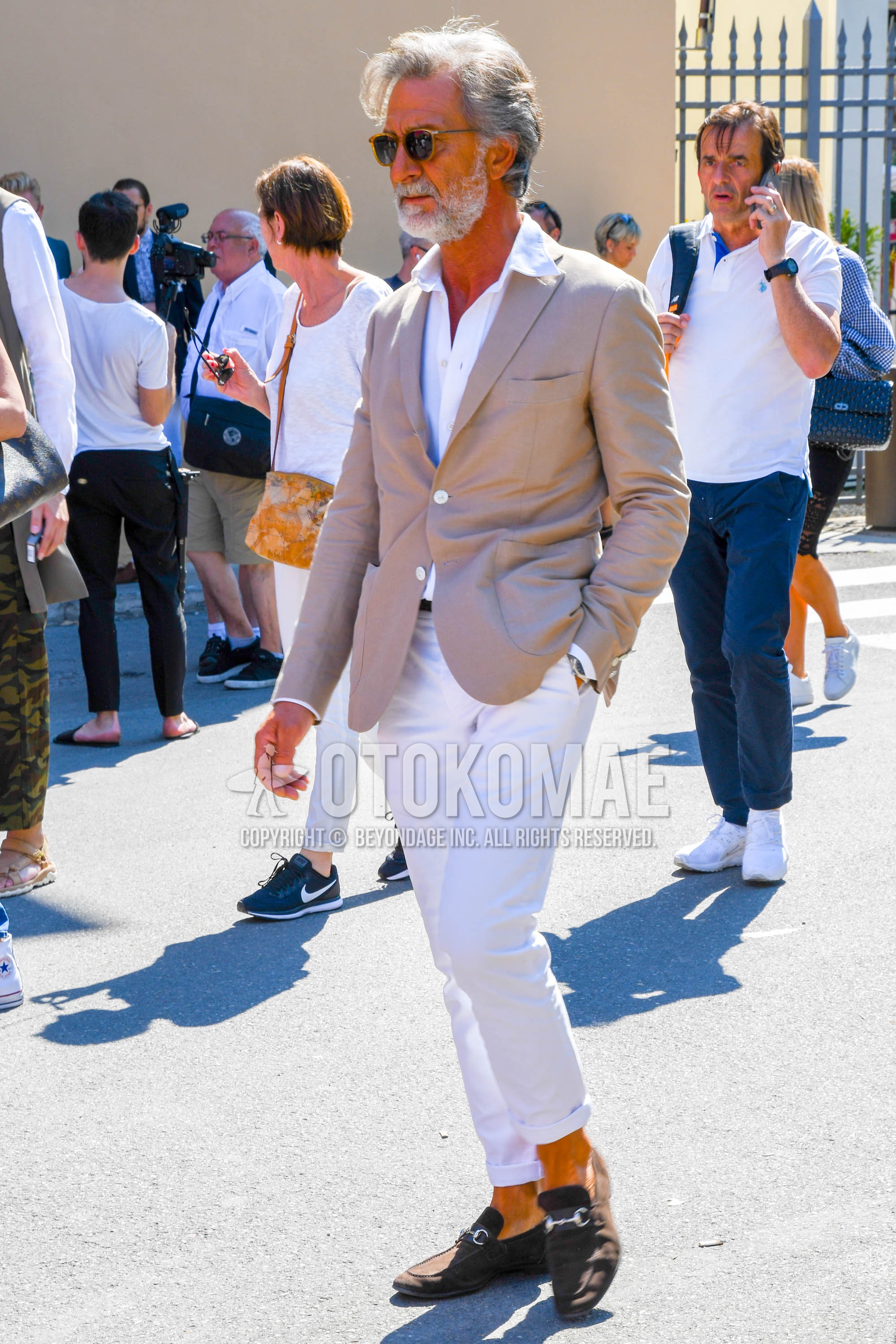 Men's spring summer autumn outfit with plain sunglasses, beige plain tailored jacket, white plain shirt, white plain chinos, brown bit loafers leather shoes.