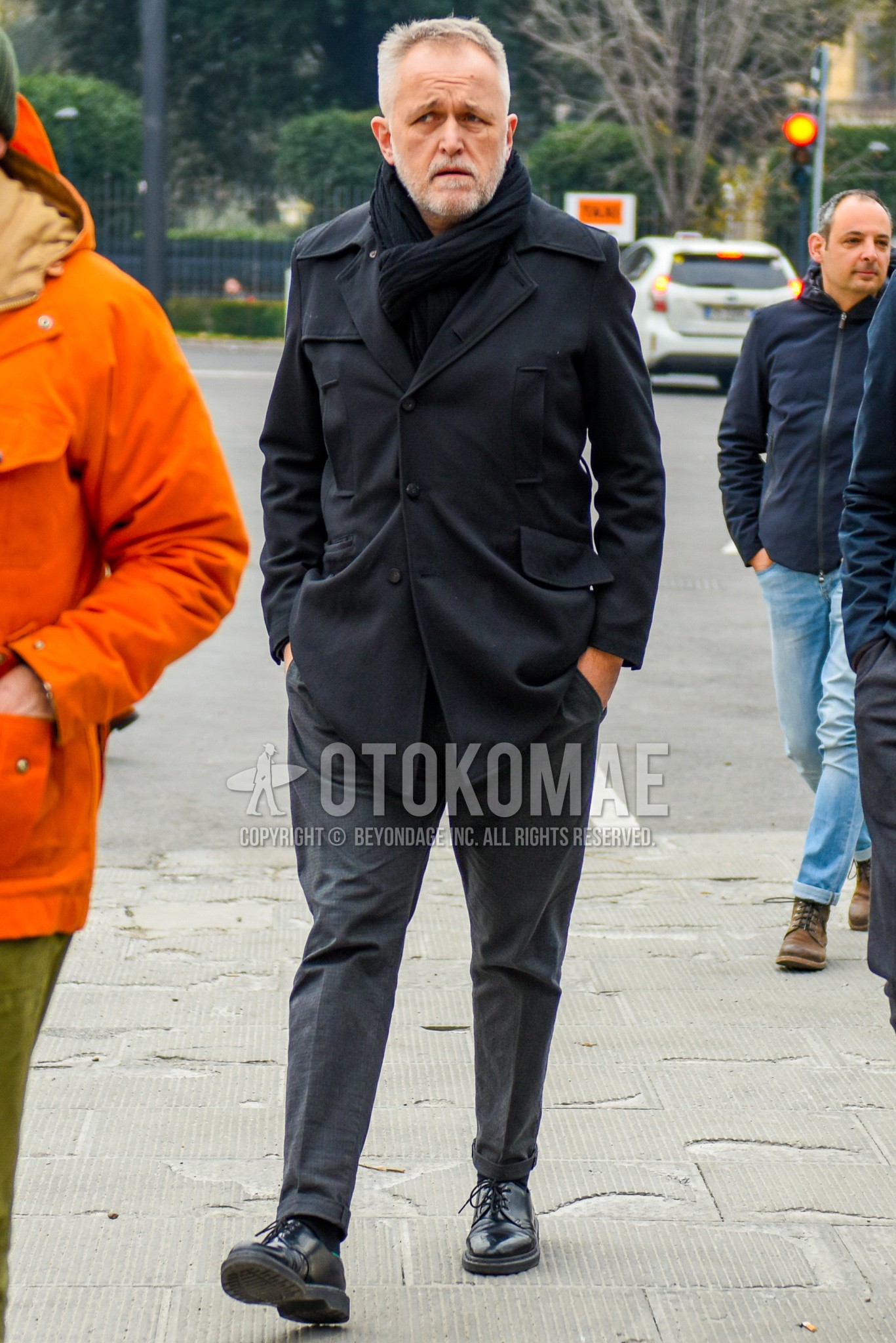 Men's autumn winter outfit with black plain scarf, black plain outerwear, gray plain slacks, black plain toe leather shoes.
