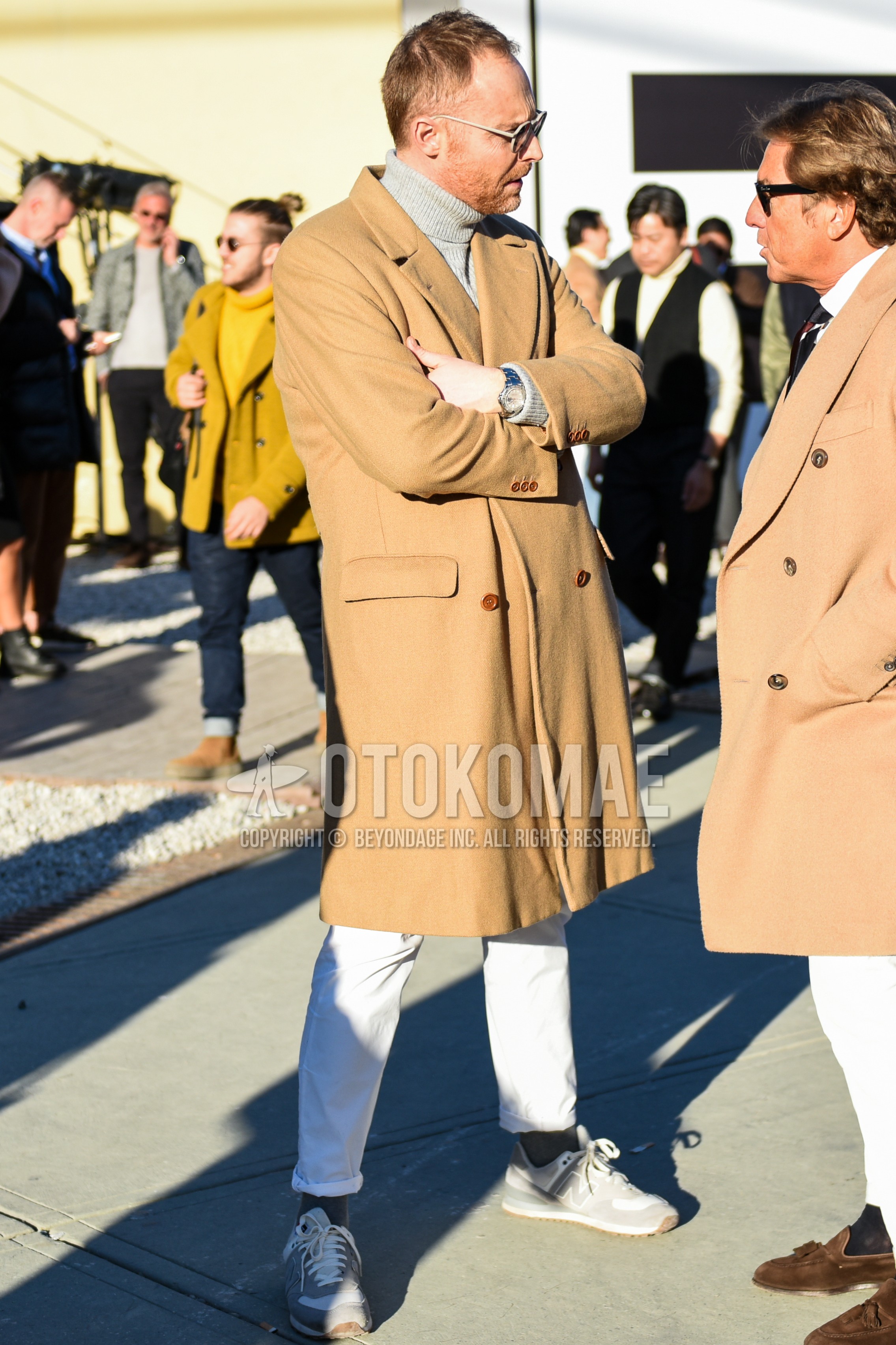 Men's autumn winter outfit with gold plain sunglasses, beige plain chester coat, gray plain turtleneck knit, white plain cotton pants, dark gray plain socks, gray low-cut sneakers.