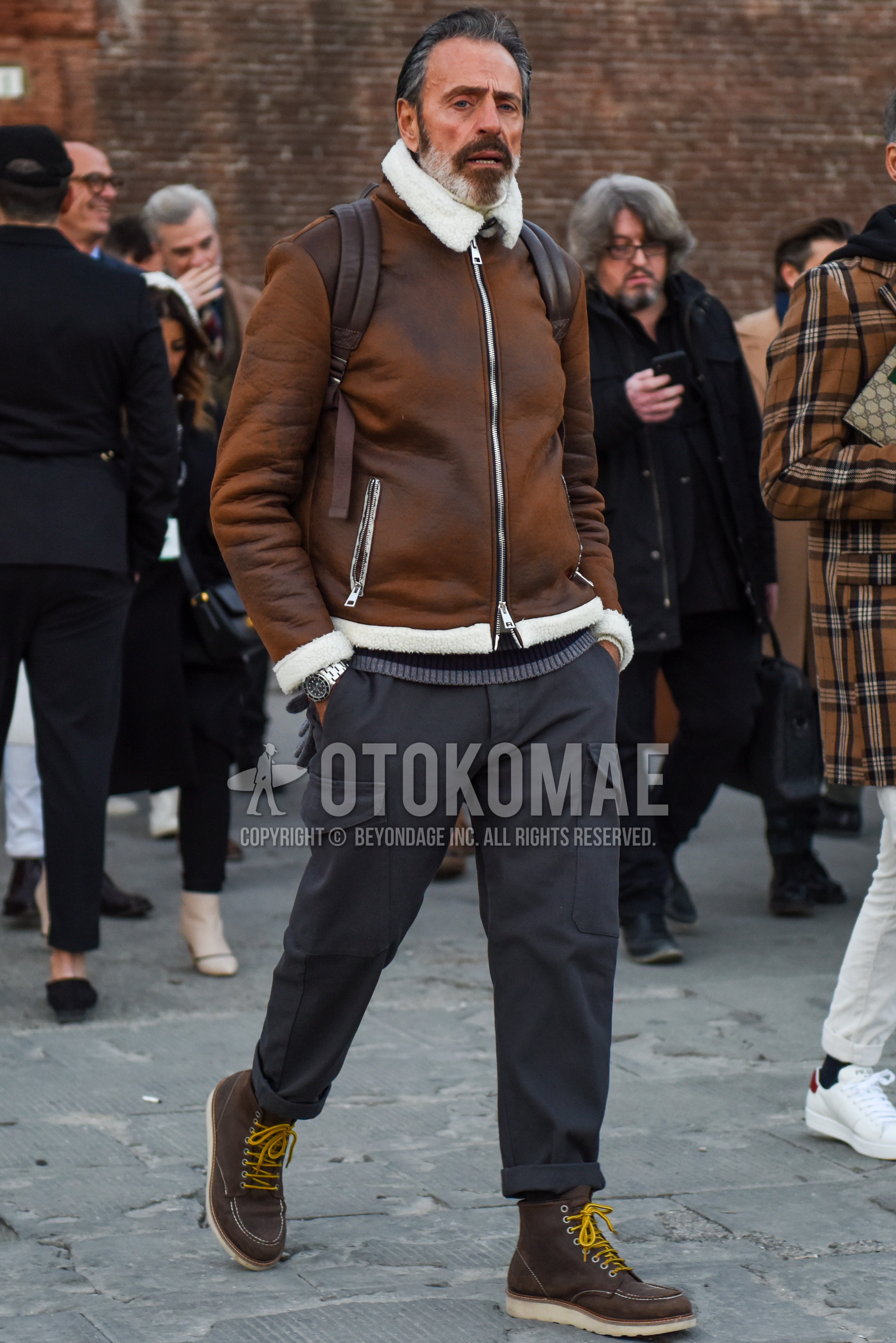 Men's autumn winter outfit with brown plain leather jacket, brown plain military jacket, gray plain cargo pants, brown work boots.