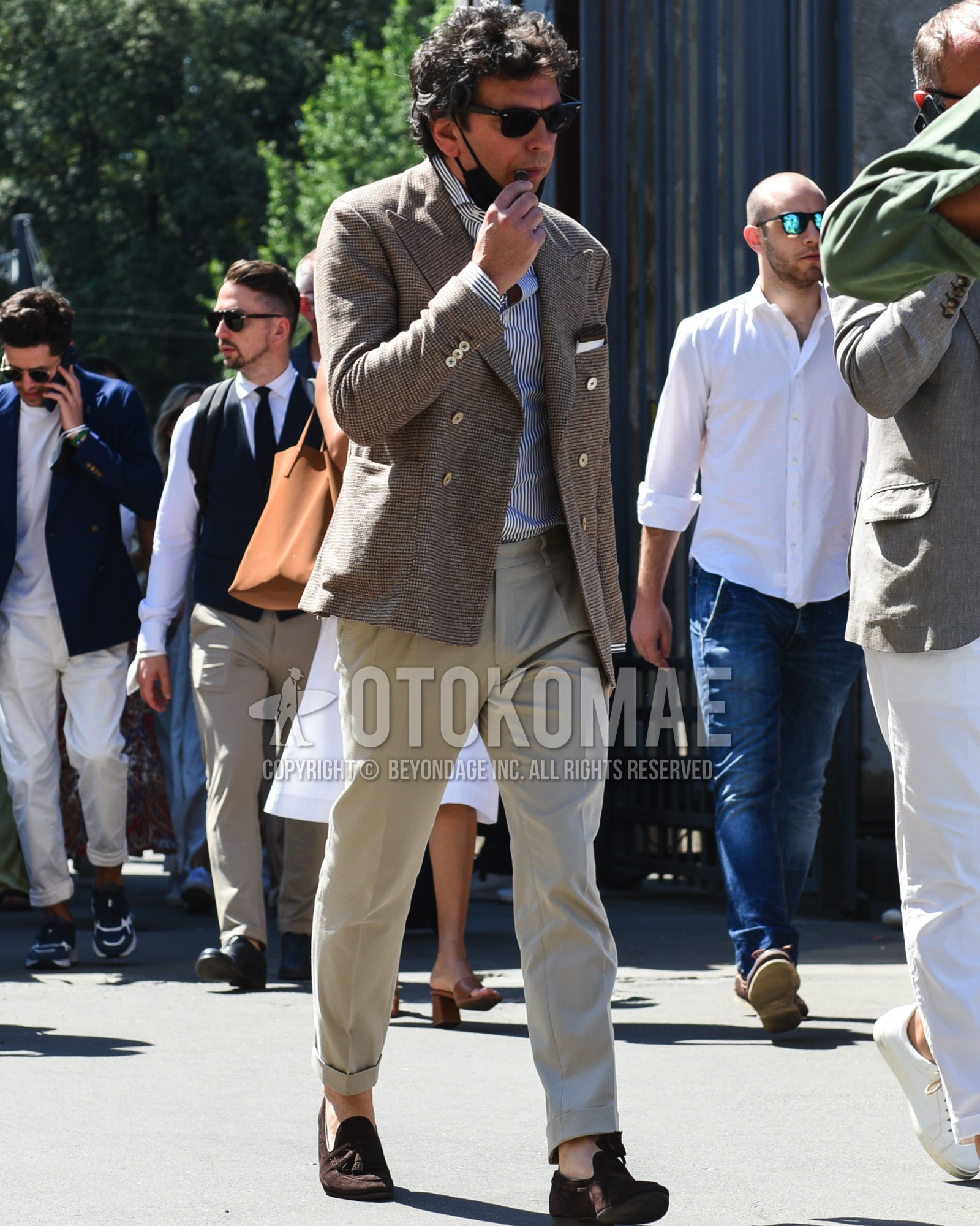 Men's spring summer outfit with black plain sunglasses, brown check tailored jacket, white navy stripes shirt, beige plain slacks, brown tassel loafers leather shoes.