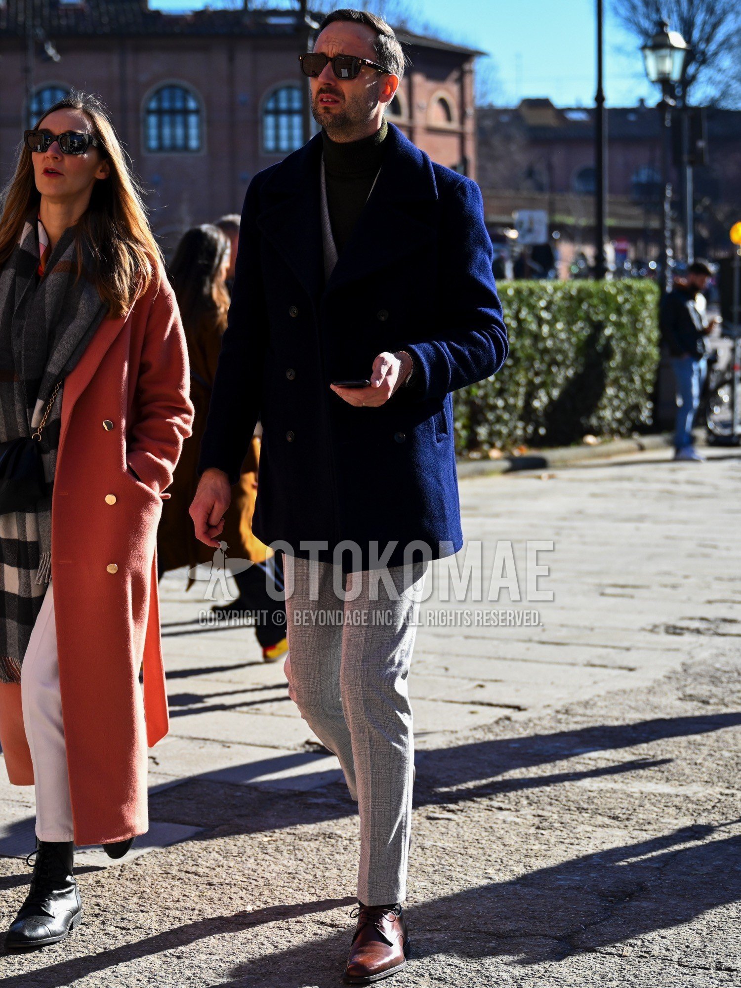 Men's autumn winter outfit with plain sunglasses, navy plain ulster coat, olive green plain turtleneck knit, gray check slacks, brown plain toe leather shoes, gray check suit.