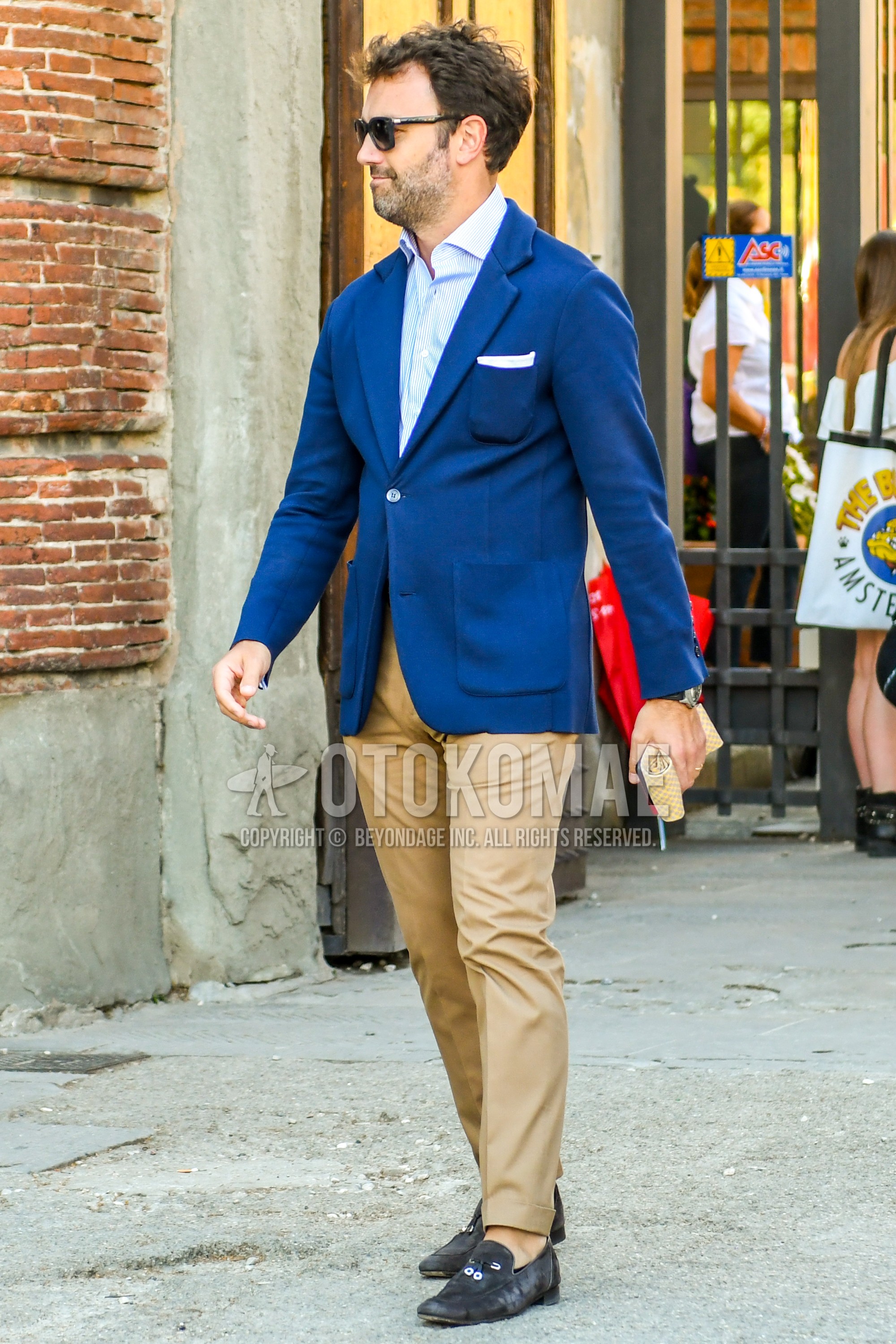 Men's spring summer autumn outfit with plain sunglasses, navy plain tailored jacket, white light blue stripes shirt, beige plain chinos, gray  loafers leather shoes, suede shoes leather shoes.