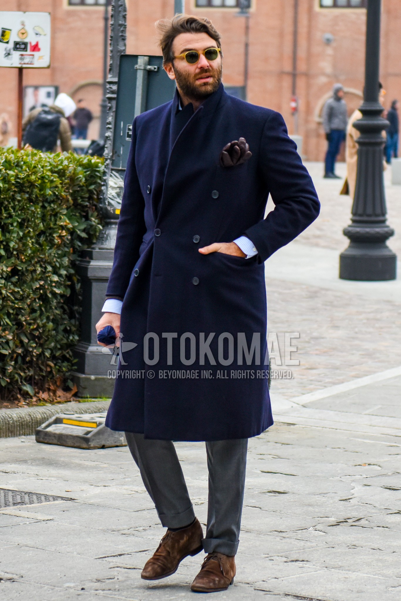 Men's winter outfit with plain sunglasses, navy plain chester coat, gray plain slacks, brown suede shoes leather shoes.