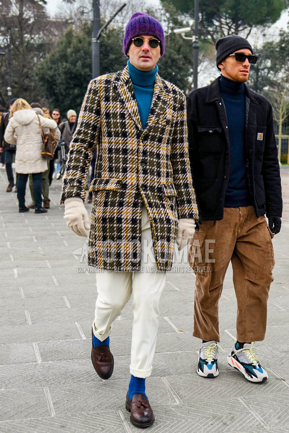 Men's winter outfit with purple plain knit cap, plain sunglasses, beige navy check chester coat, blue plain sweater, white plain slacks, blue plain socks, brown tassel loafers leather shoes.