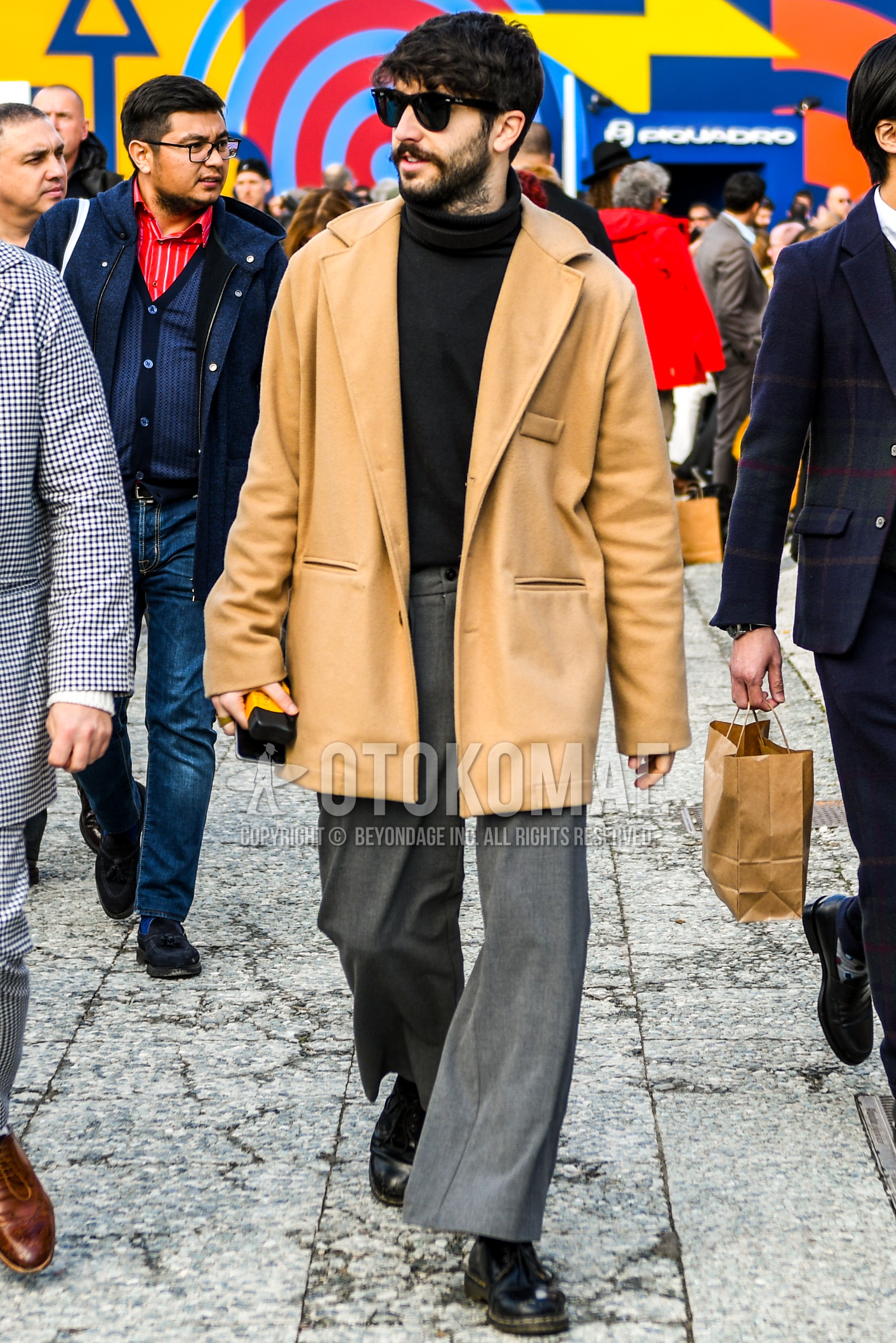 Men's autumn winter outfit with plain sunglasses, beige plain chester coat, black plain turtleneck knit, gray plain slacks, black plain toe leather shoes.