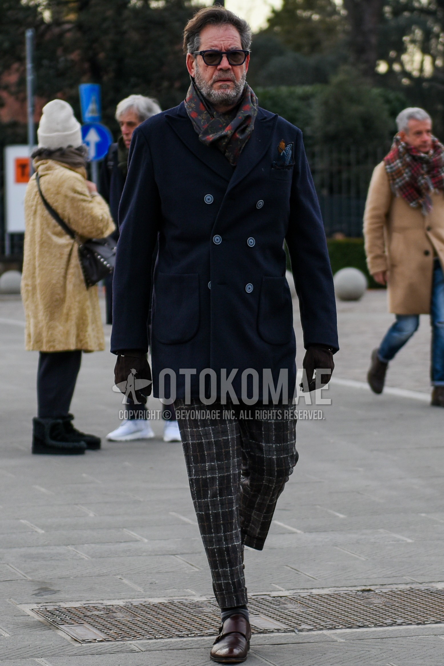 Men's autumn winter outfit with black plain sunglasses, multi-color botanical scarf, navy plain p coat, brown check slacks, gray horizontal stripes socks, brown monk shoes leather shoes.