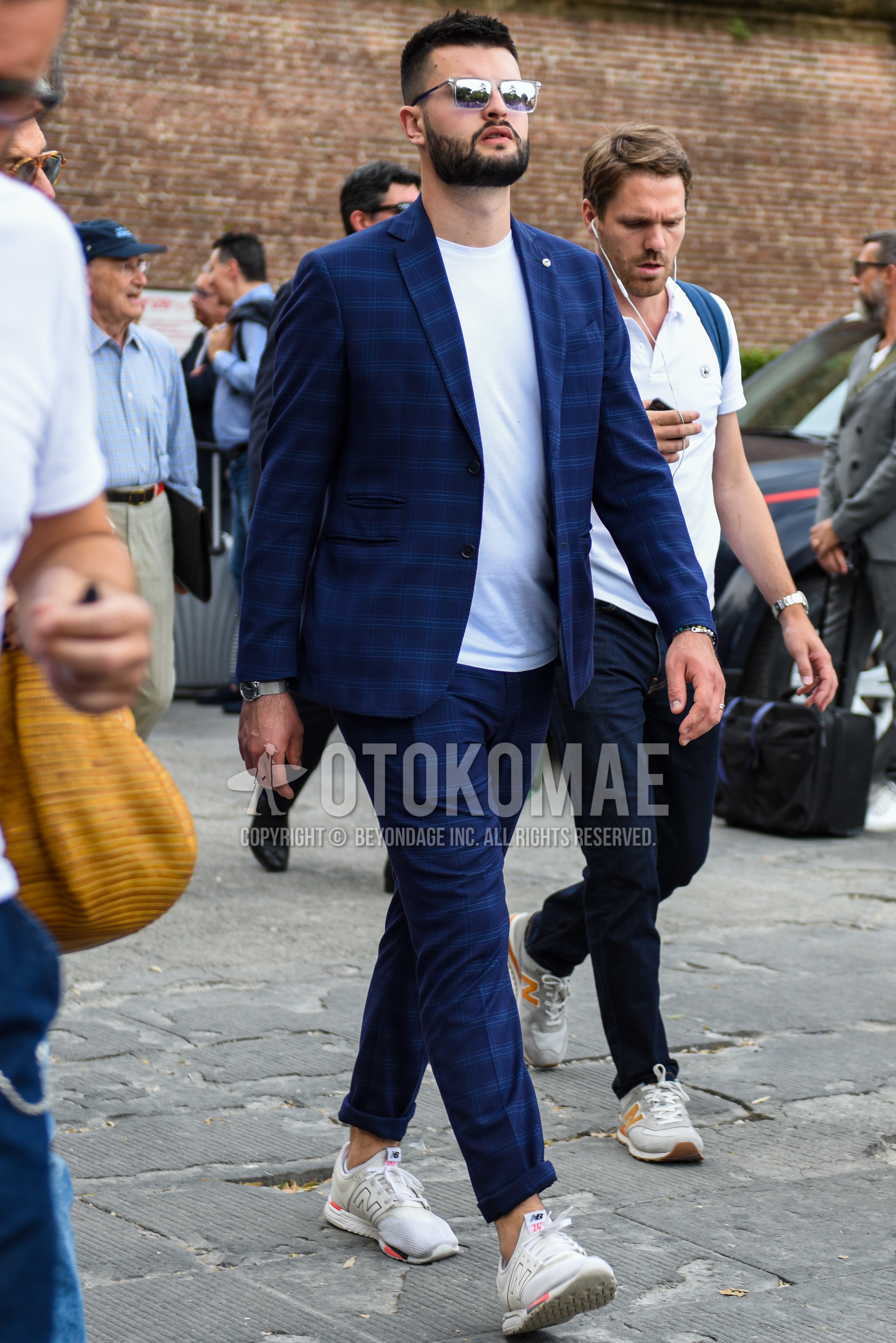Men's spring summer outfit with white silver plain sunglasses, white plain t-shirt, white low-cut sneakers, navy check suit.