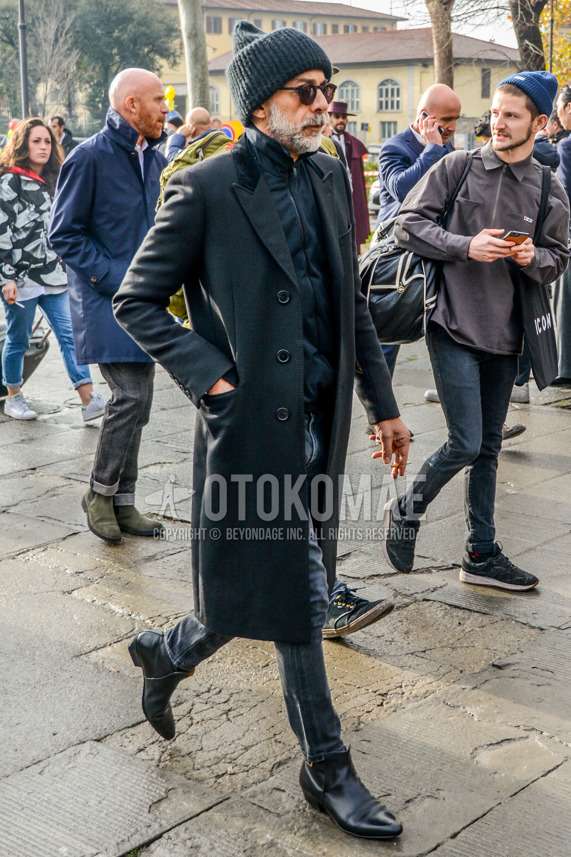 Men's autumn winter outfit with plain knit cap, plain sunglasses, black plain chester coat, black plain cardigan, gray plain denim/jeans, black  boots.