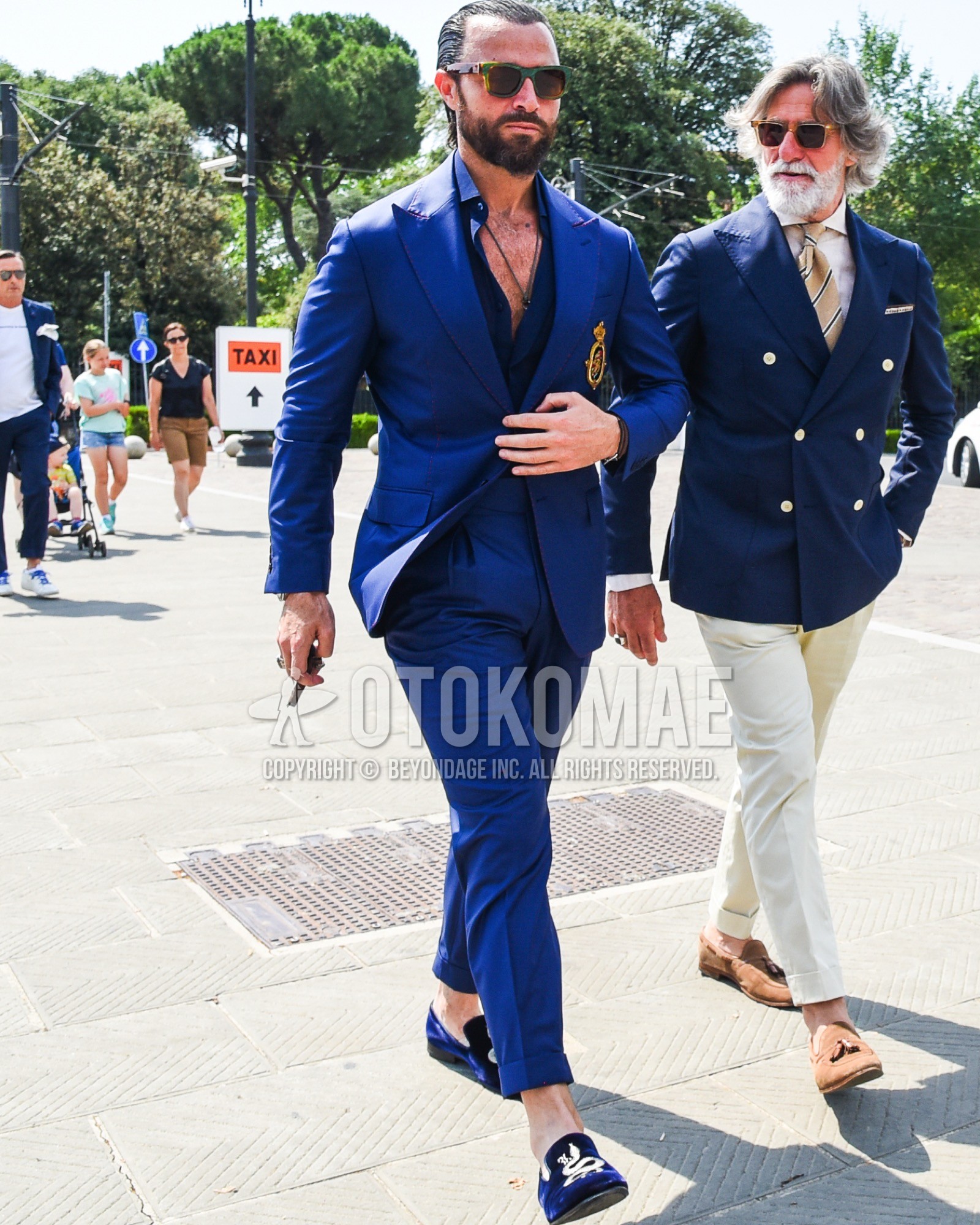 Men's spring summer outfit with green eyewear sunglasses, blue plain shirt,  loafers leather shoes, blue plain suit.