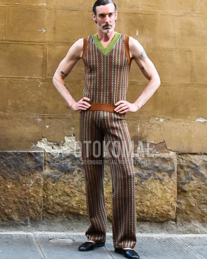 Men's spring summer outfit with black leather sandals, brown multi-color stripes casual setup.