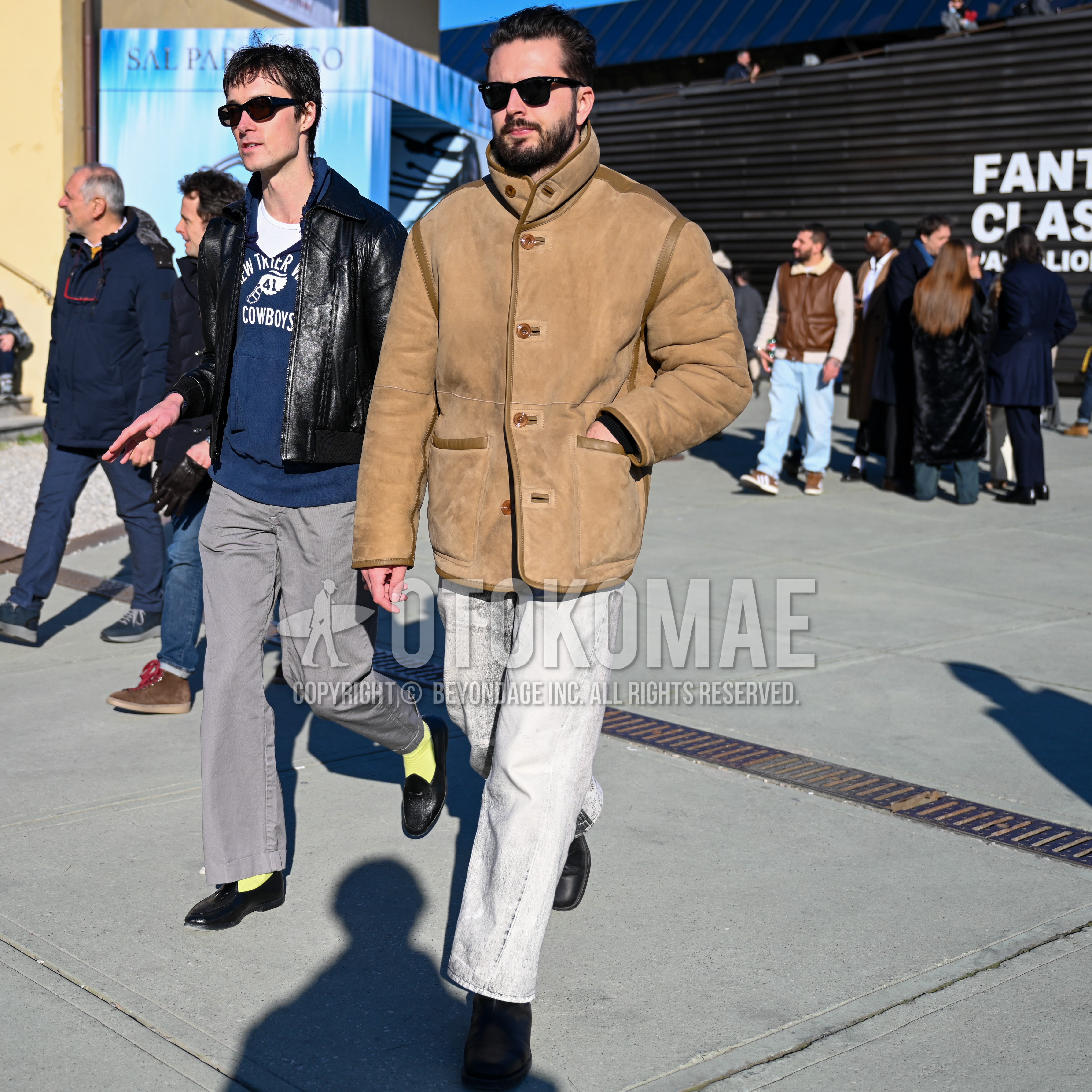 Men's spring autumn winter outfit with black plain sunglasses, beige plain leather jacket, gray plain denim/jeans, black  boots.