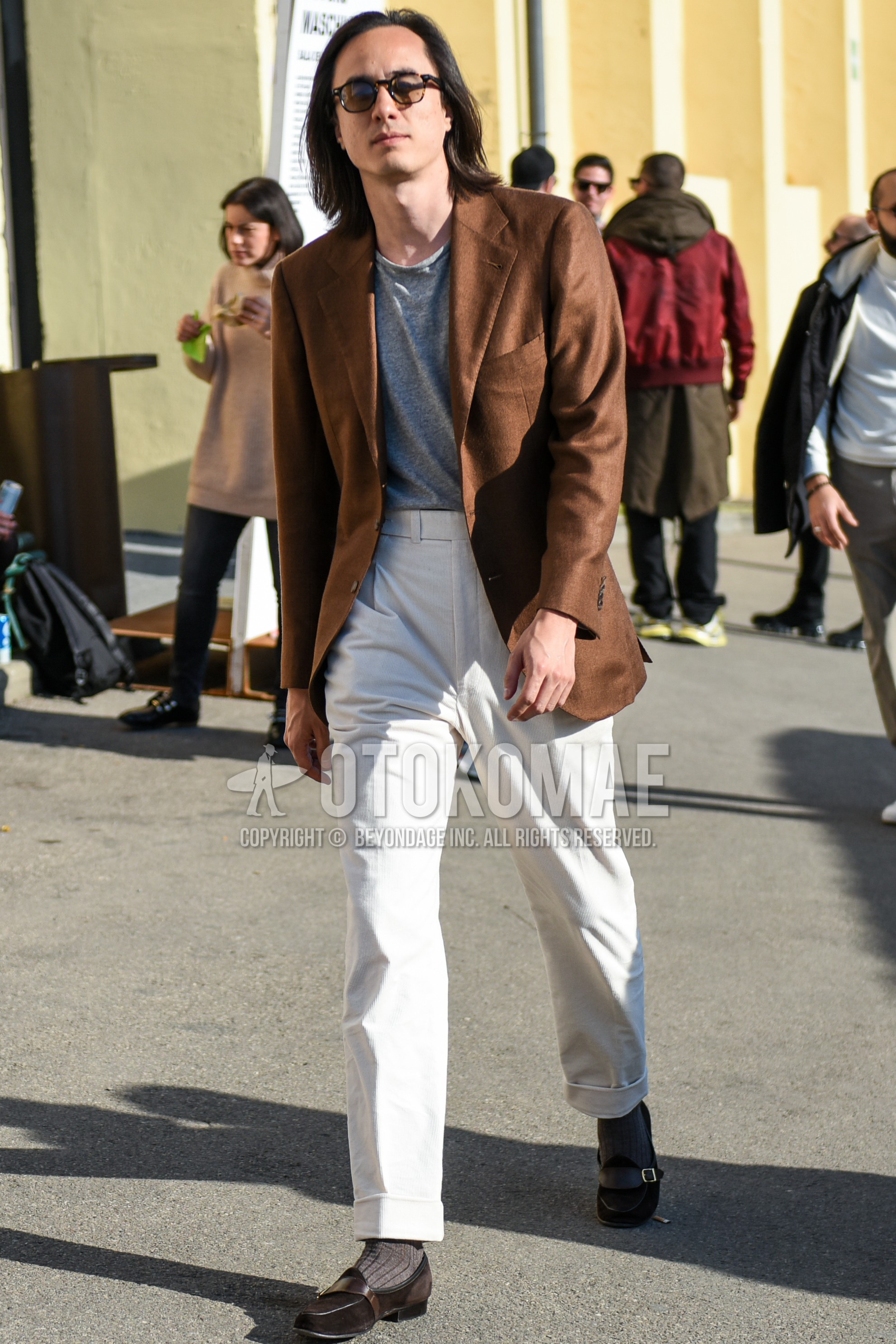 Men's spring autumn outfit with brown tortoiseshell glasses, brown plain tailored jacket, gray plain t-shirt, white plain slacks, gray plain socks, brown  loafers leather shoes.