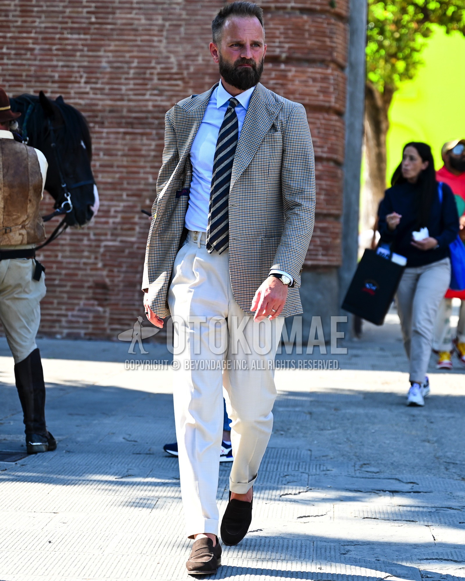 Men's spring summer autumn outfit with gray check tailored jacket, light blue plain shirt, white plain slacks, white plain pleated pants, brown coin loafers leather shoes, brown suede shoes leather shoes, navy regimental necktie.