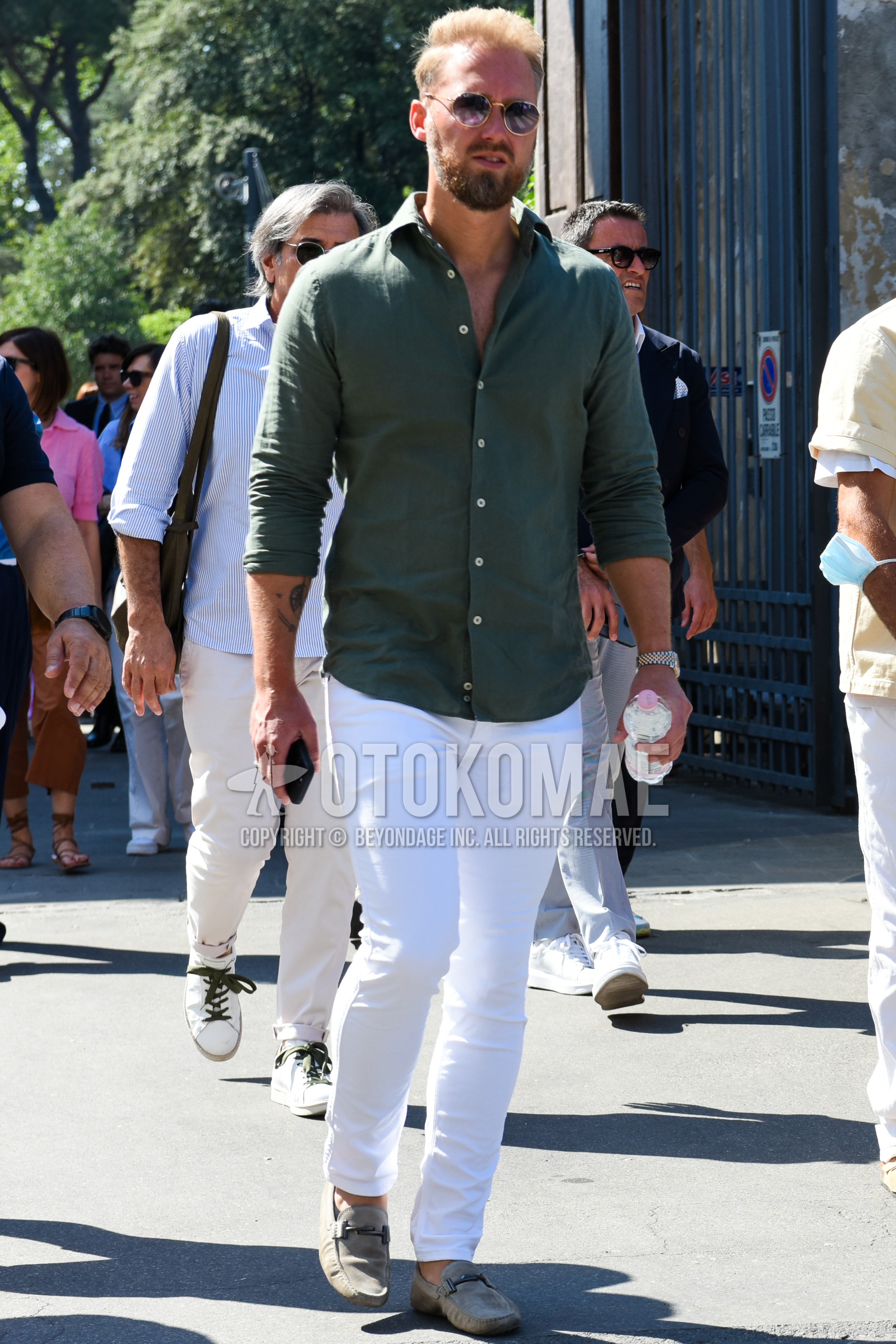 Men's spring summer outfit with gold plain sunglasses, olive green plain shirt, white plain denim/jeans, gray bit loafers leather shoes.