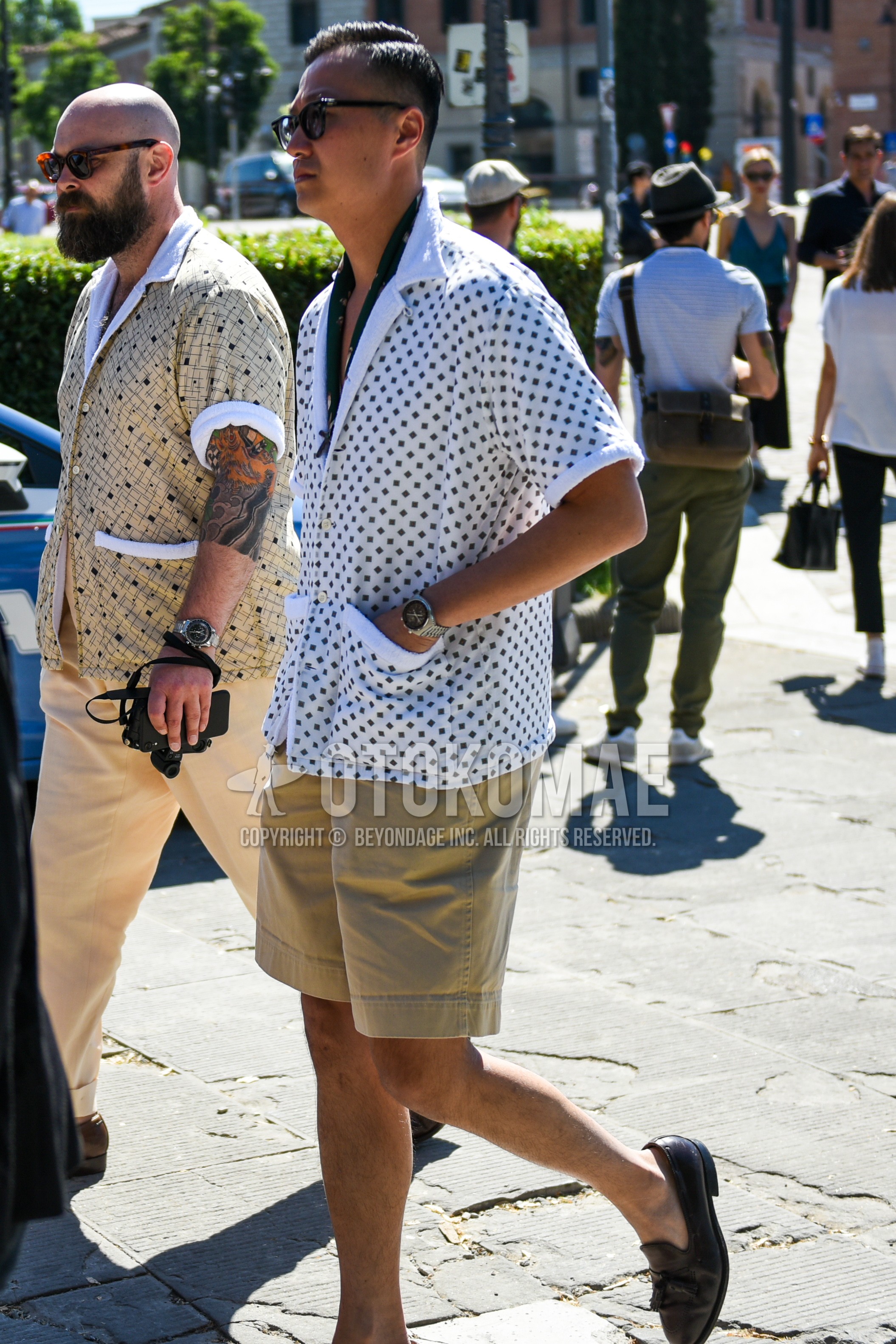 Men's summer outfit with black plain sunglasses, olive green scarf bandana/neckerchief, white tops/innerwear shirt, beige plain chinos, plain short pants, brown tassel loafers leather shoes.