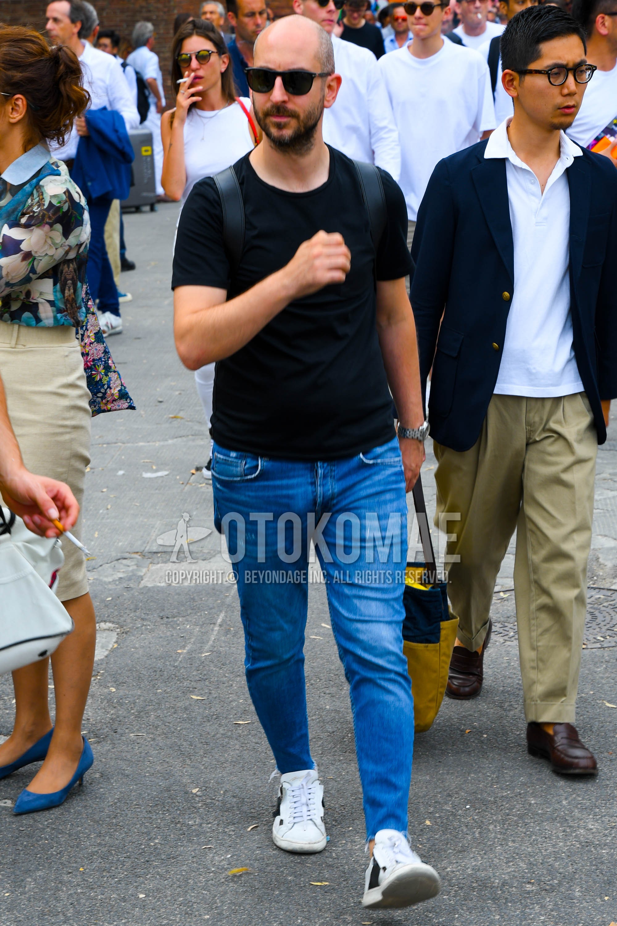 Men's summer outfit with plain sunglasses, black plain t-shirt, blue plain denim/jeans, white low-cut sneakers.