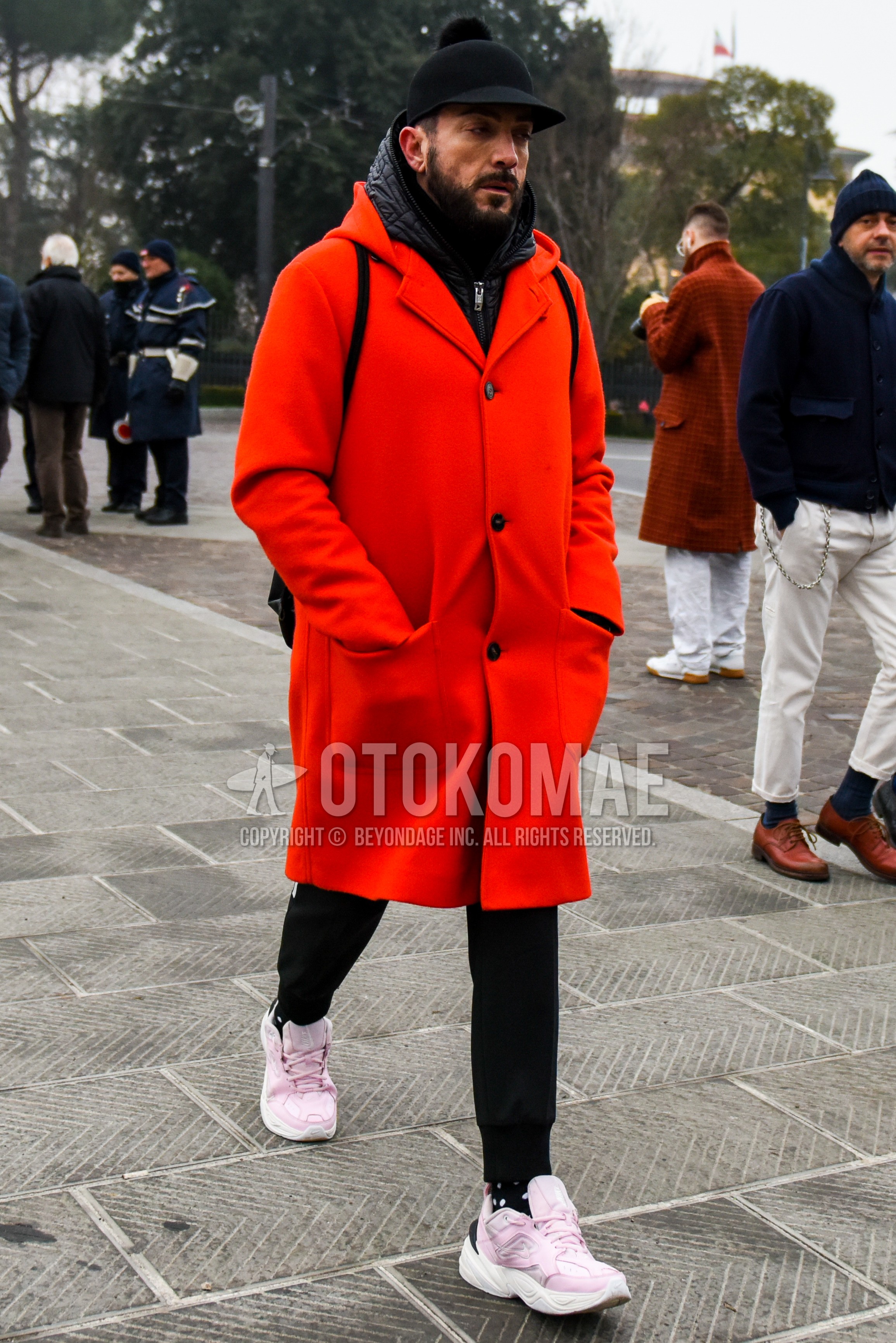 Men's winter outfit with black plain cap, red plain chester coat, black plain inner down, black plain jogger pants/ribbed pants, black dots socks, pink low-cut sneakers.