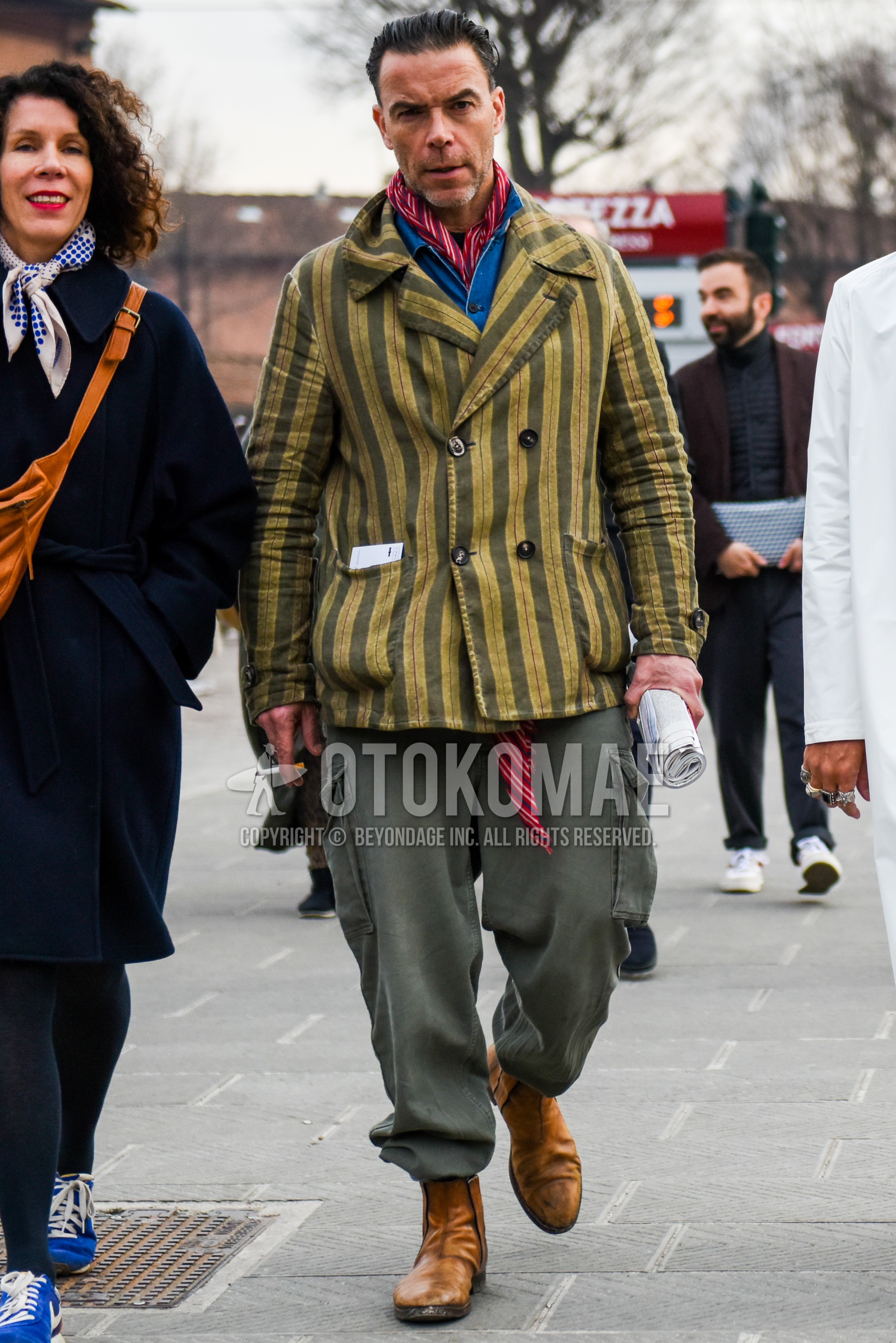Men's autumn winter outfit with red scarf scarf, gray beige stripes outerwear, light blue plain shirt, olive green plain cargo pants, beige  boots.
