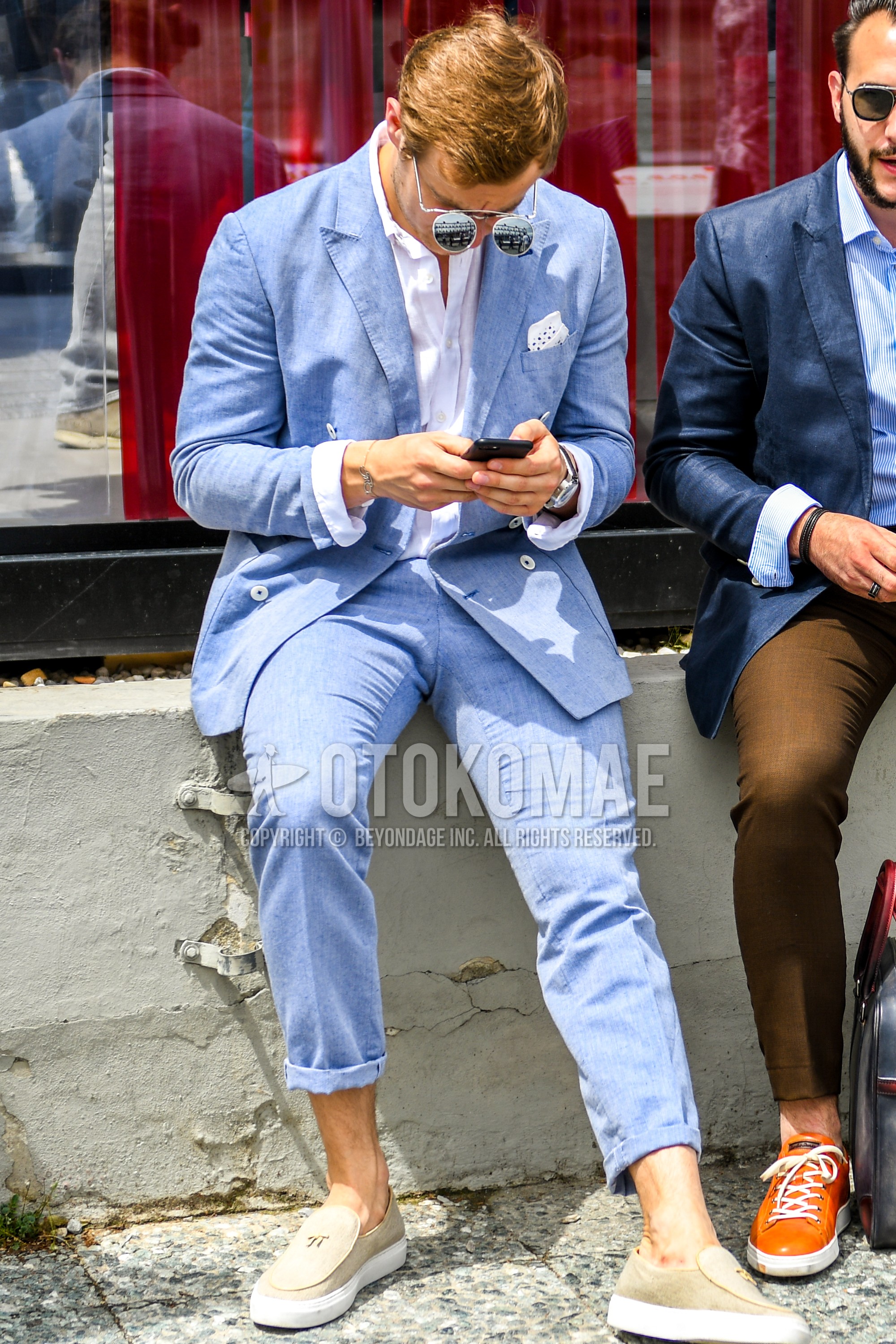 Men's spring summer autumn outfit with silver plain sunglasses, white plain shirt, beige slip-on sneakers, light blue plain suit.