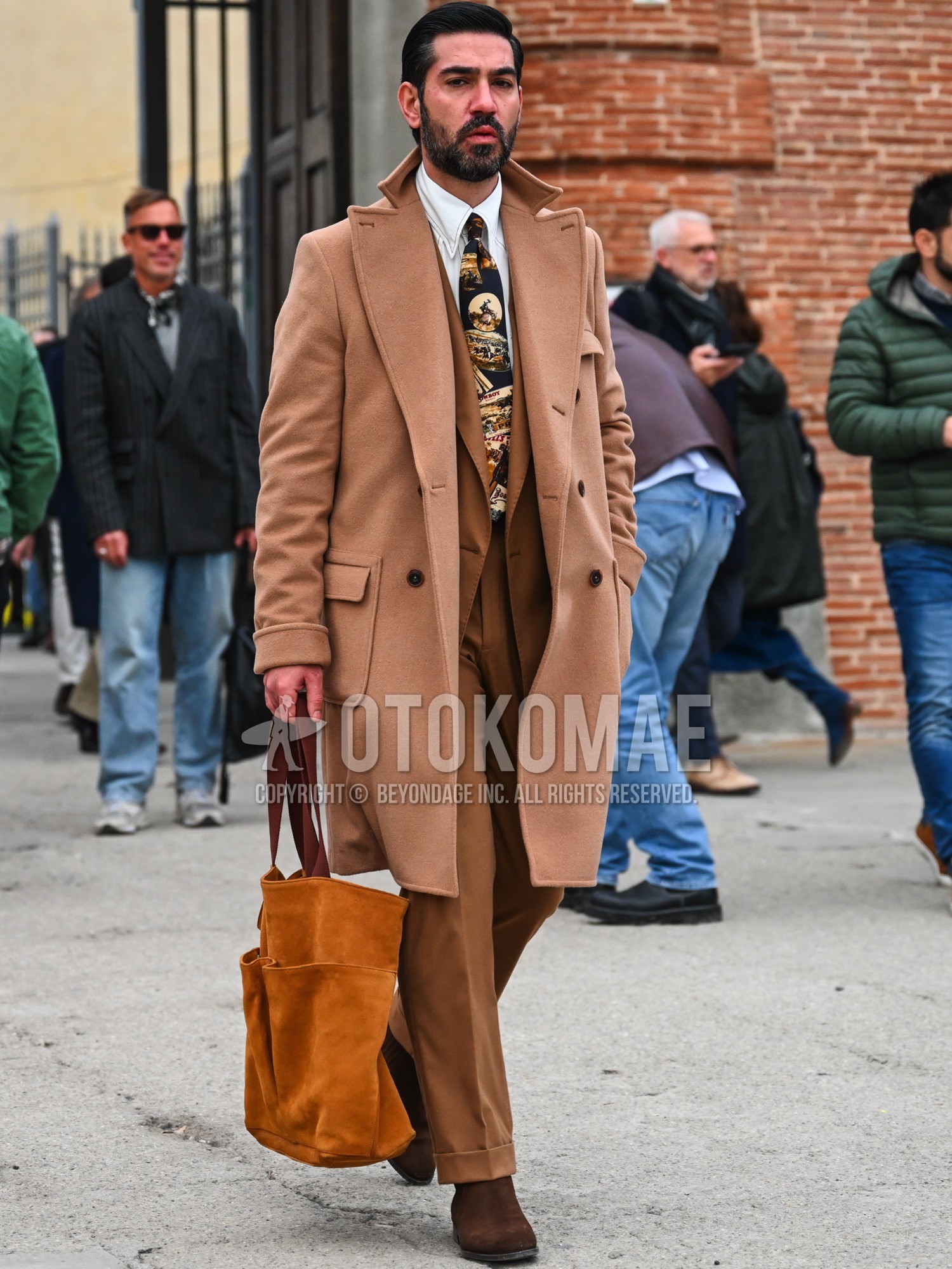 Men's autumn winter outfit with brown plain chester coat, white plain shirt, brown side-gore boots, brown plain tote bag, brown plain suit, black graphic necktie.