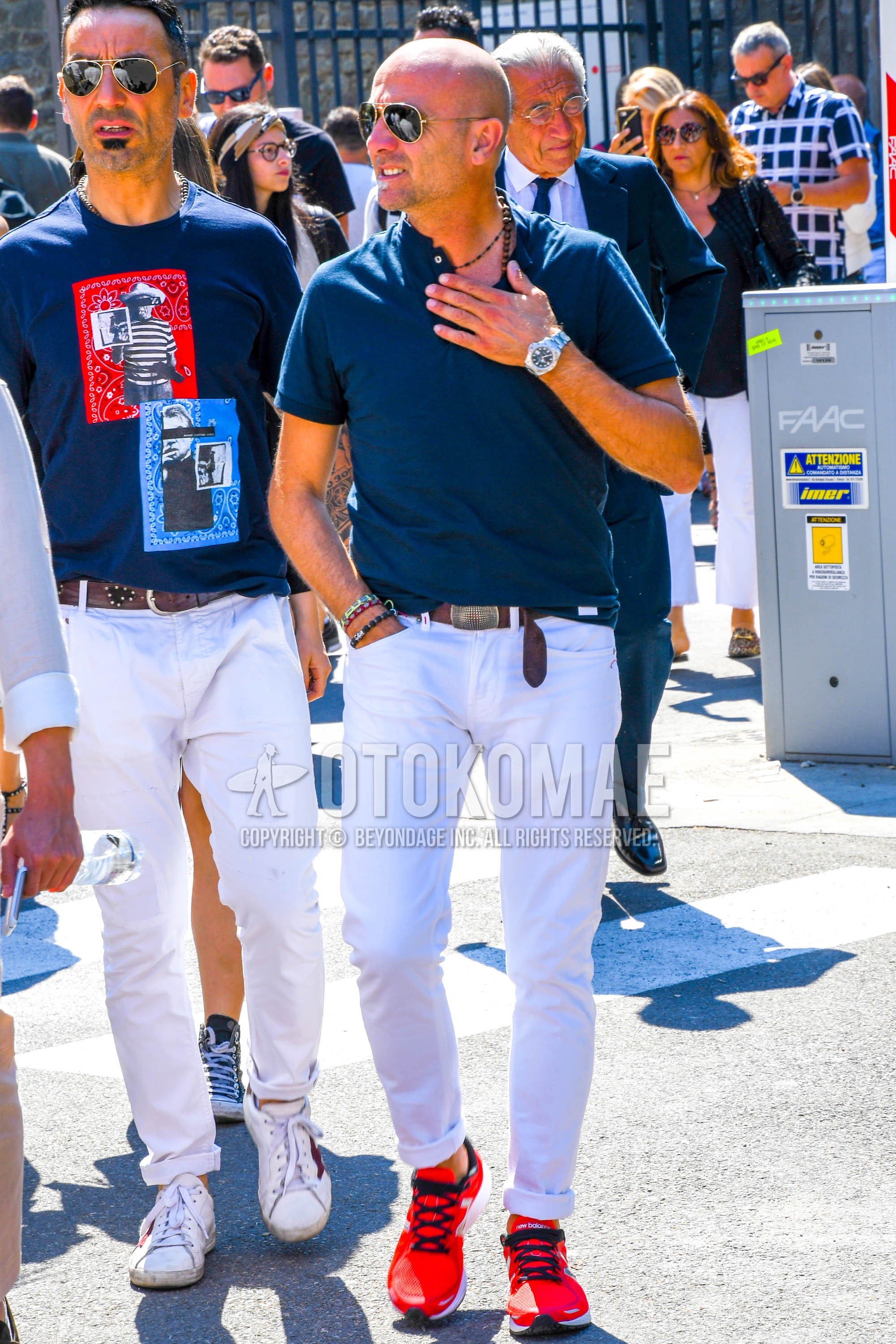 Men's summer outfit with plain sunglasses, navy plain t-shirt, brown plain leather belt, white plain denim/jeans, red low-cut sneakers.