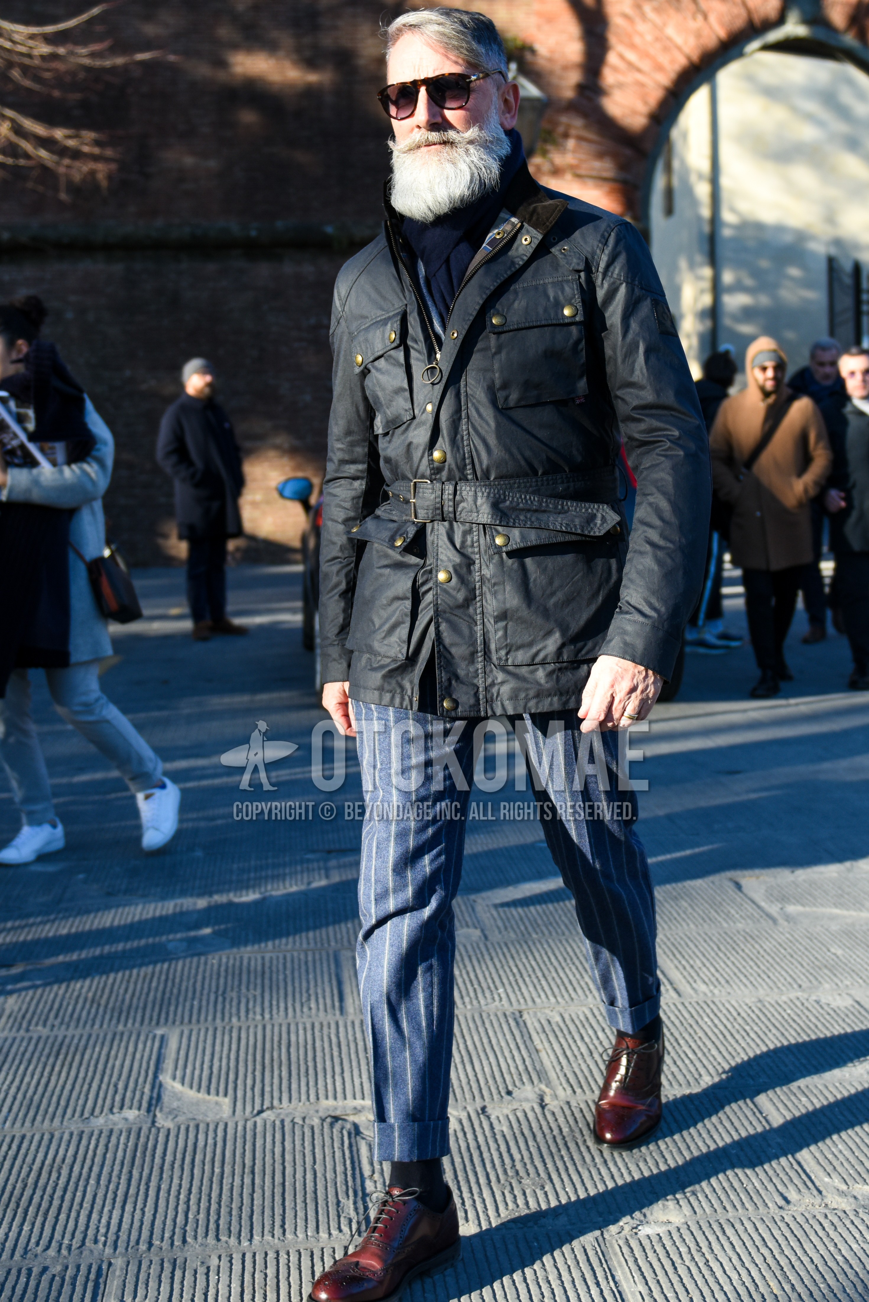 Men's winter outfit with plain sunglasses, navy plain scarf, black plain field jacket/hunting jacket, navy stripes slacks, dark gray plain socks, brown brogue shoes leather shoes.