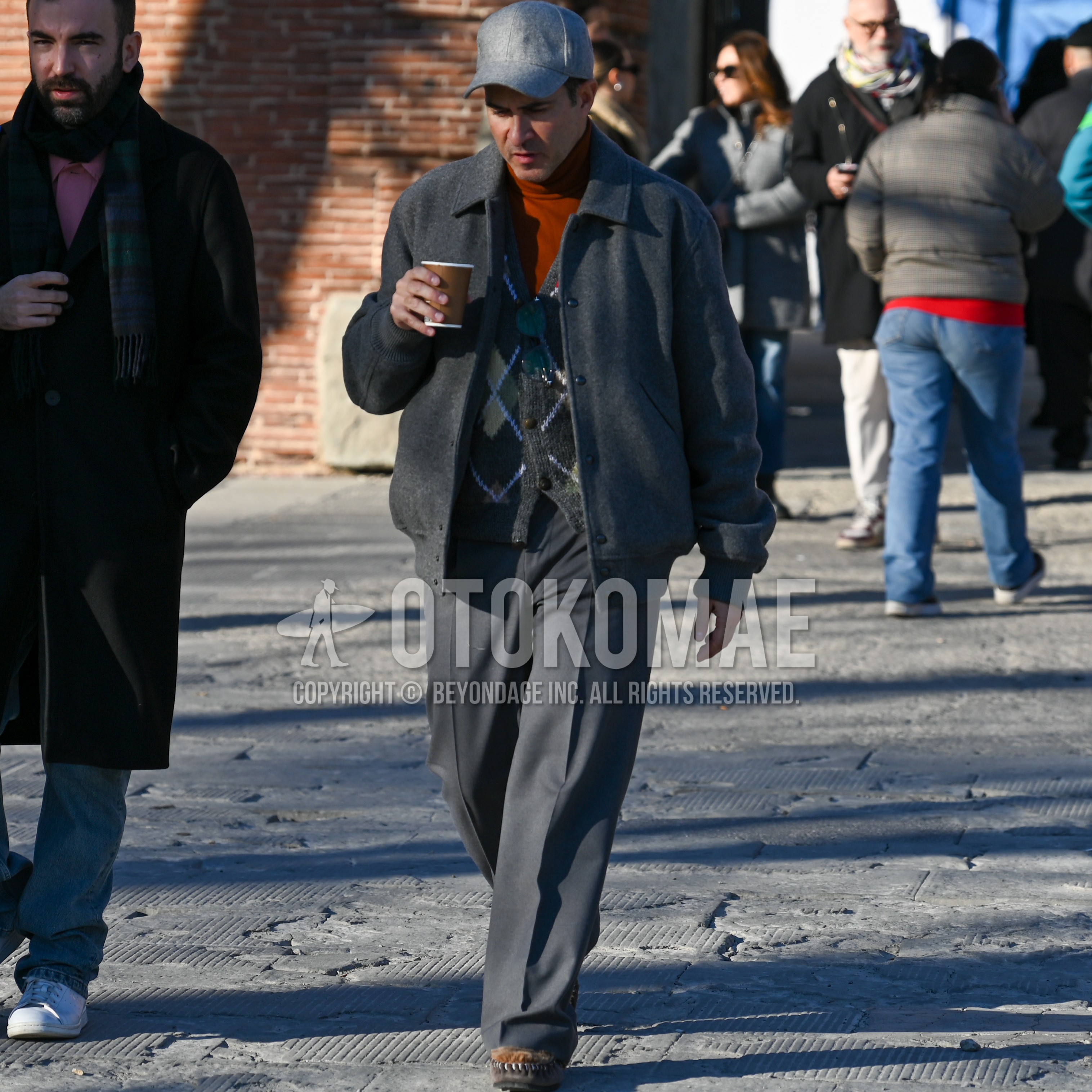 Men's winter outfit with gray plain baseball cap, gray plain stadium jacket, gray tops/innerwear cardigan, orange plain t-shirt, gray plain slacks, brown moccasins/deck shoes leather shoes.