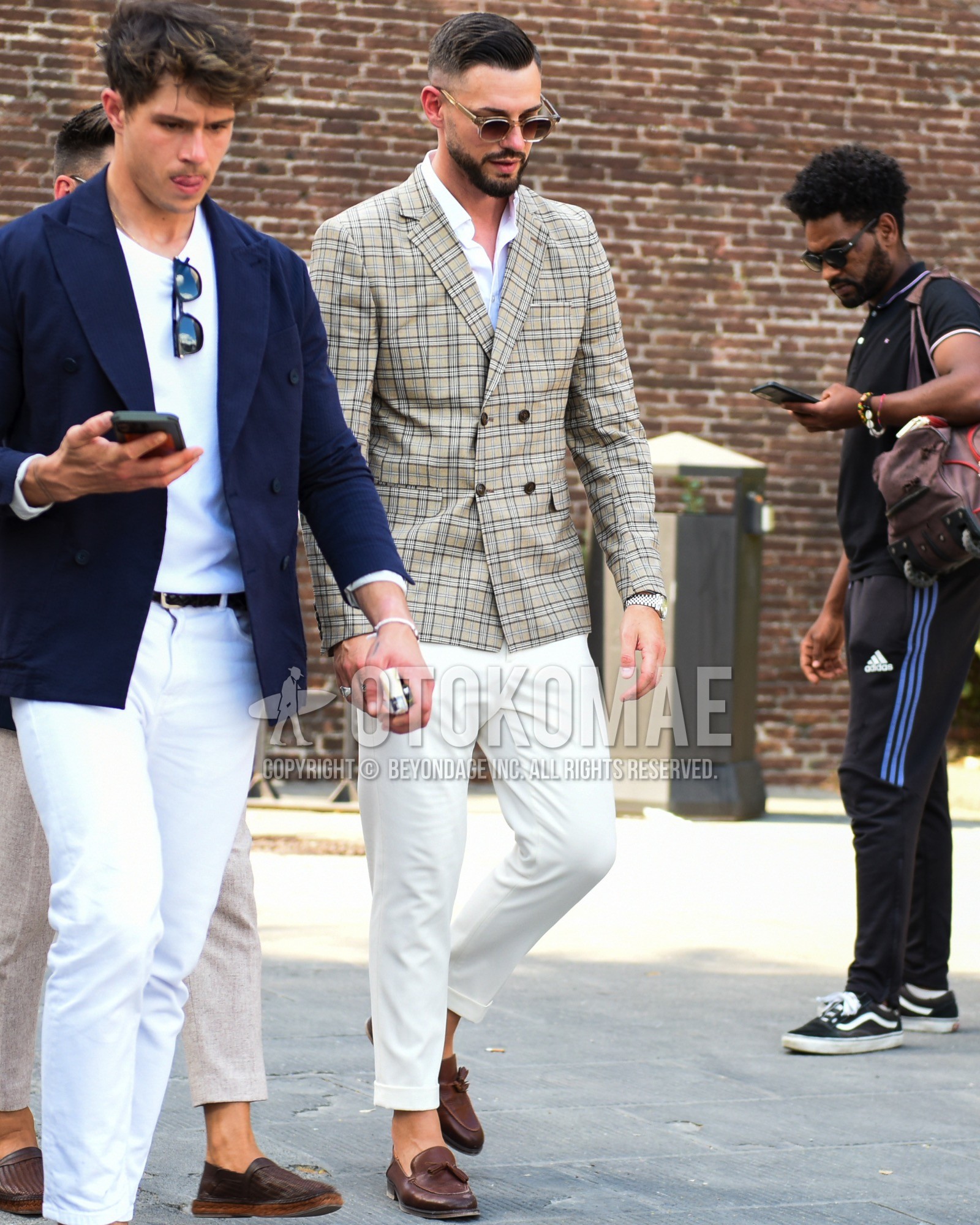 Men's spring summer outfit with clear beige plain sunglasses, gray check tailored jacket, white plain shirt, white plain cotton pants, white plain cropped pants, brown tassel loafers leather shoes.
