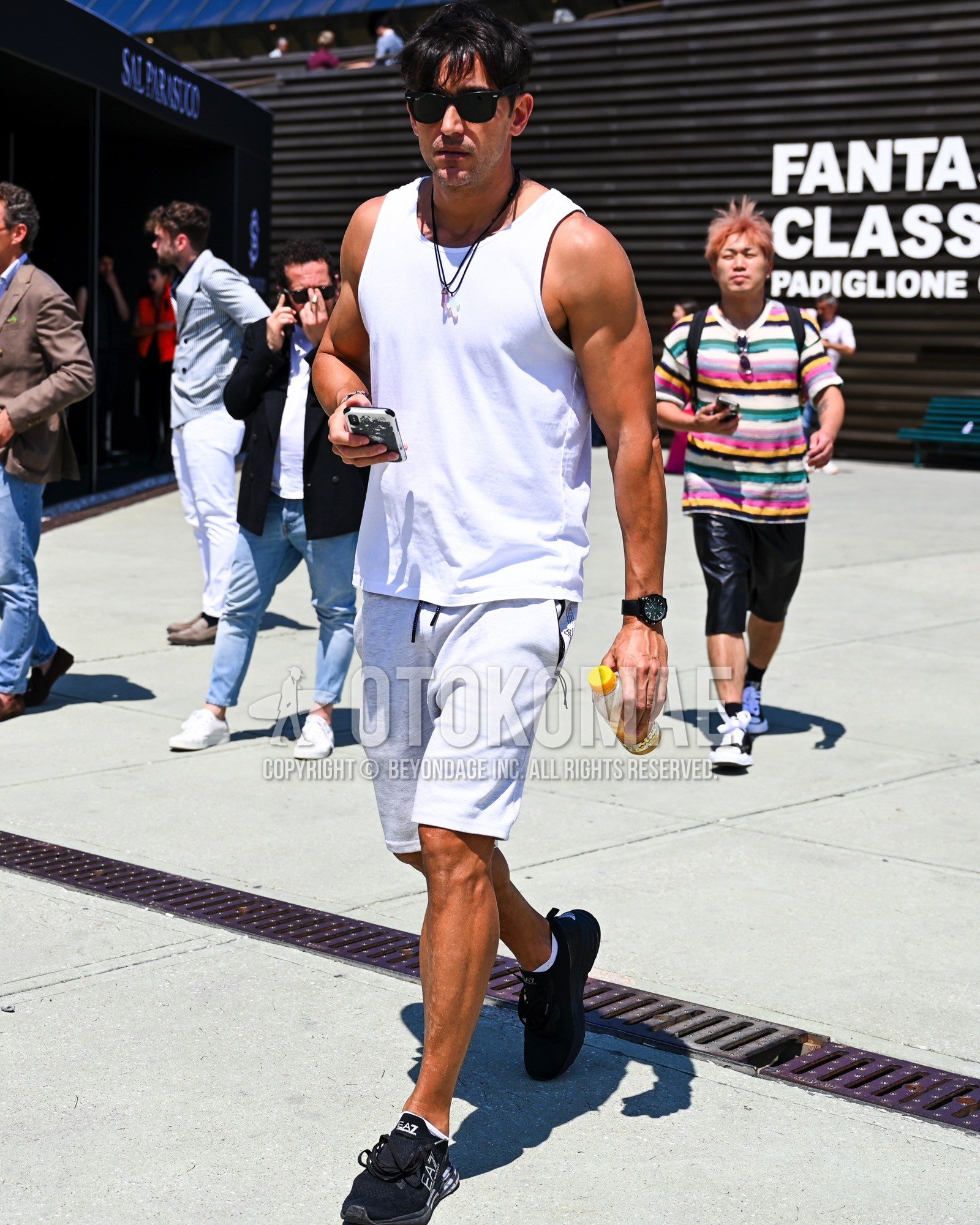 Men's spring summer outfit with white plain tank top, white plain short pants, white plain socks, black low-cut sneakers.