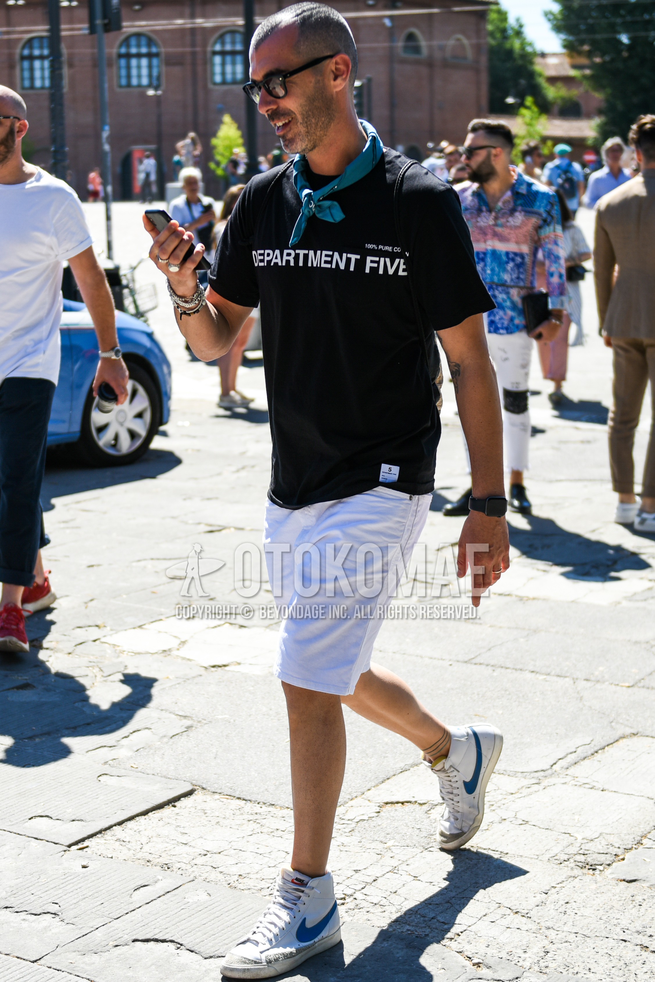 Men's summer outfit with black plain sunglasses, blue plain bandana/neckerchief, black deca logo t-shirt, white plain short pants, plain denim/jeans, white high-cut sneakers.