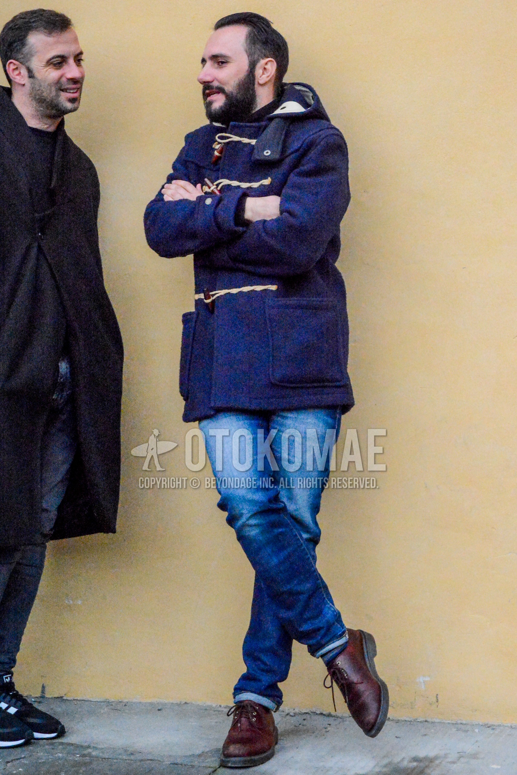 Men's autumn winter outfit with navy plain duffle coat, blue plain denim/jeans, brown plain toe leather shoes.