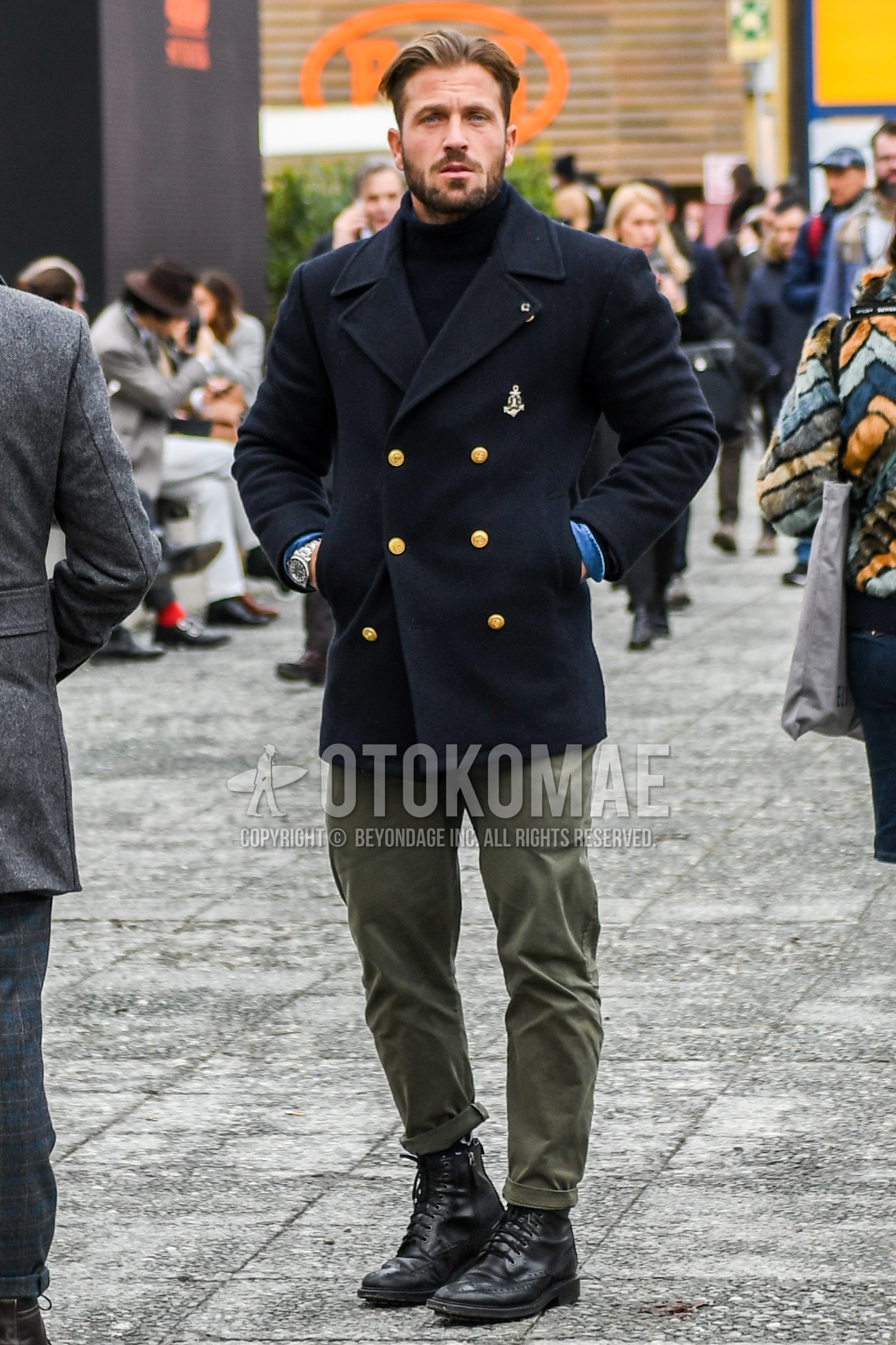 Men's winter outfit with black plain p coat, black plain turtleneck knit, olive green plain chinos, black country boots.