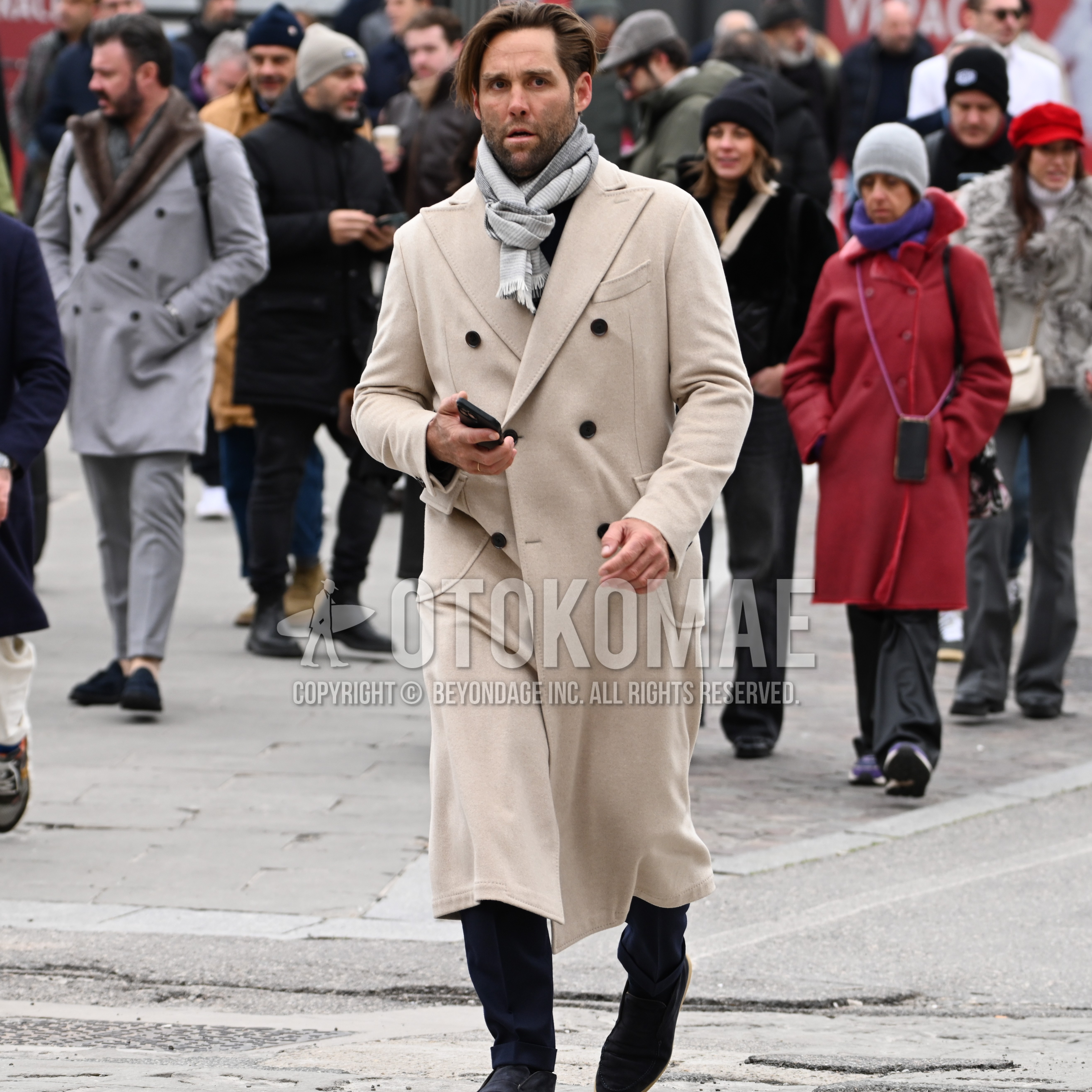Men's autumn winter outfit with gray horizontal stripes scarf, beige plain ulster coat, navy plain slacks, black suede shoes leather shoes.