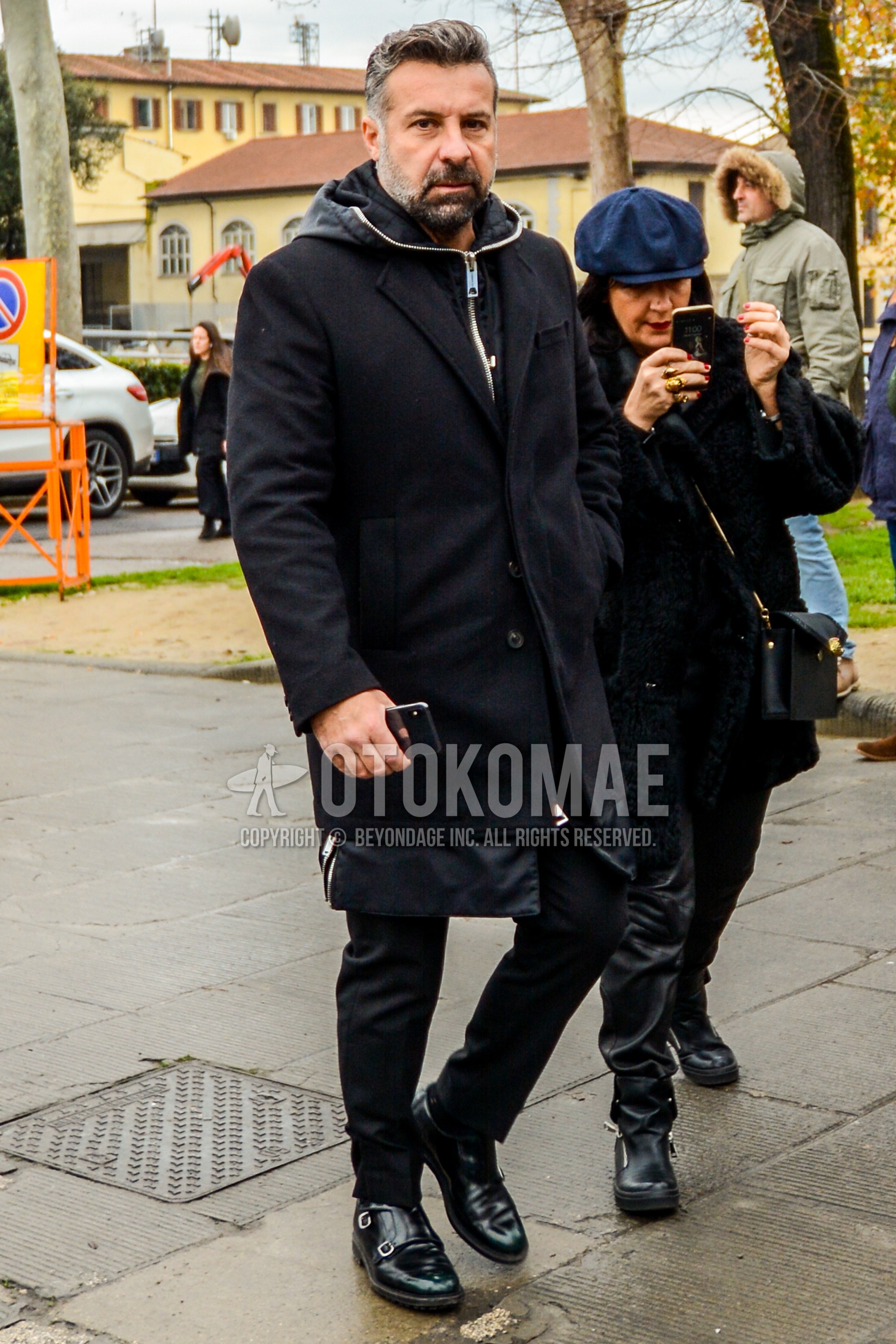 Men's autumn winter outfit with black plain chester coat, black plain hoodie, black plain slacks, black monk shoes leather shoes.