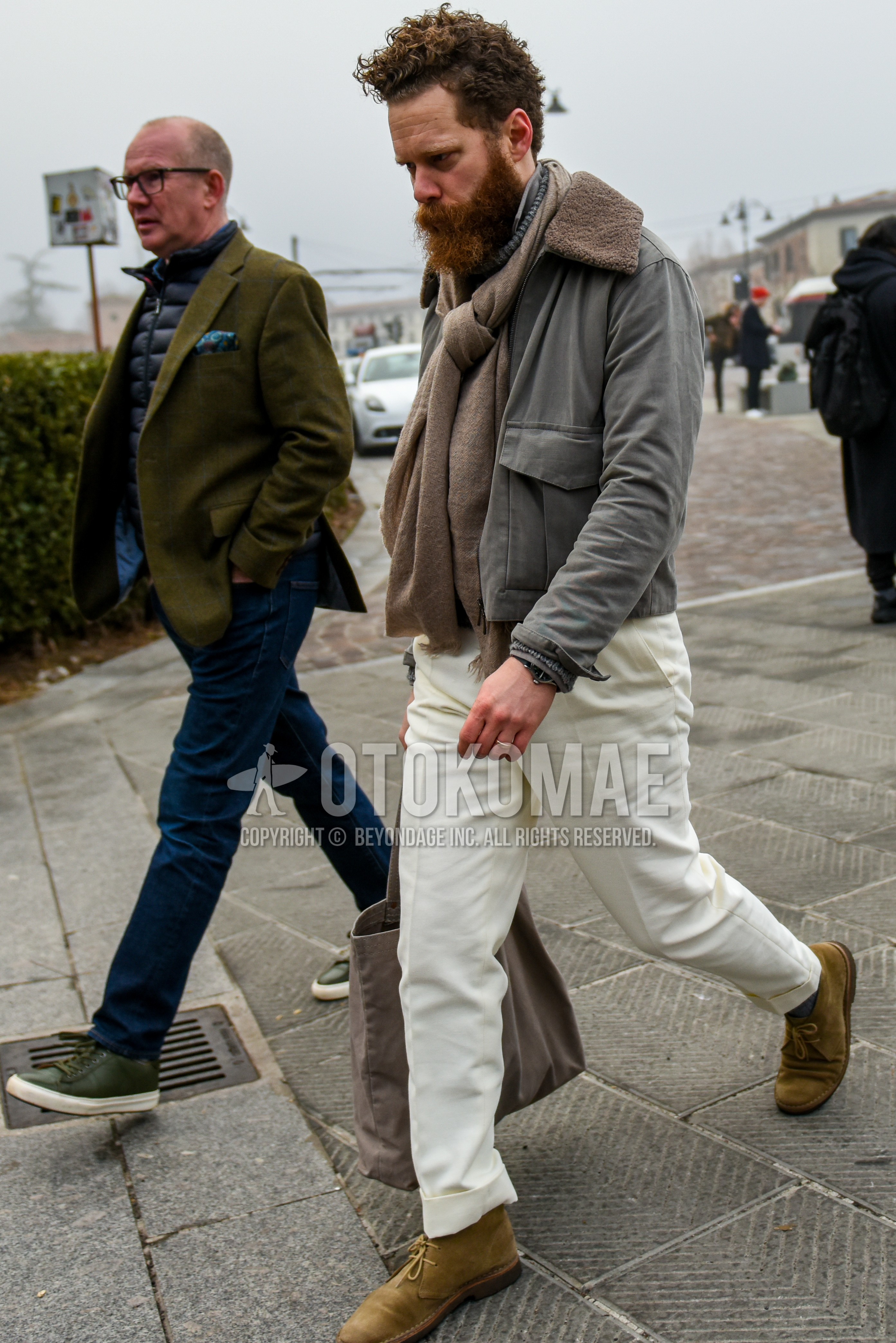 Men's winter outfit with beige plain scarf, gray plain military jacket, white plain cotton pants, beige chukka boots, suede shoes leather shoes.