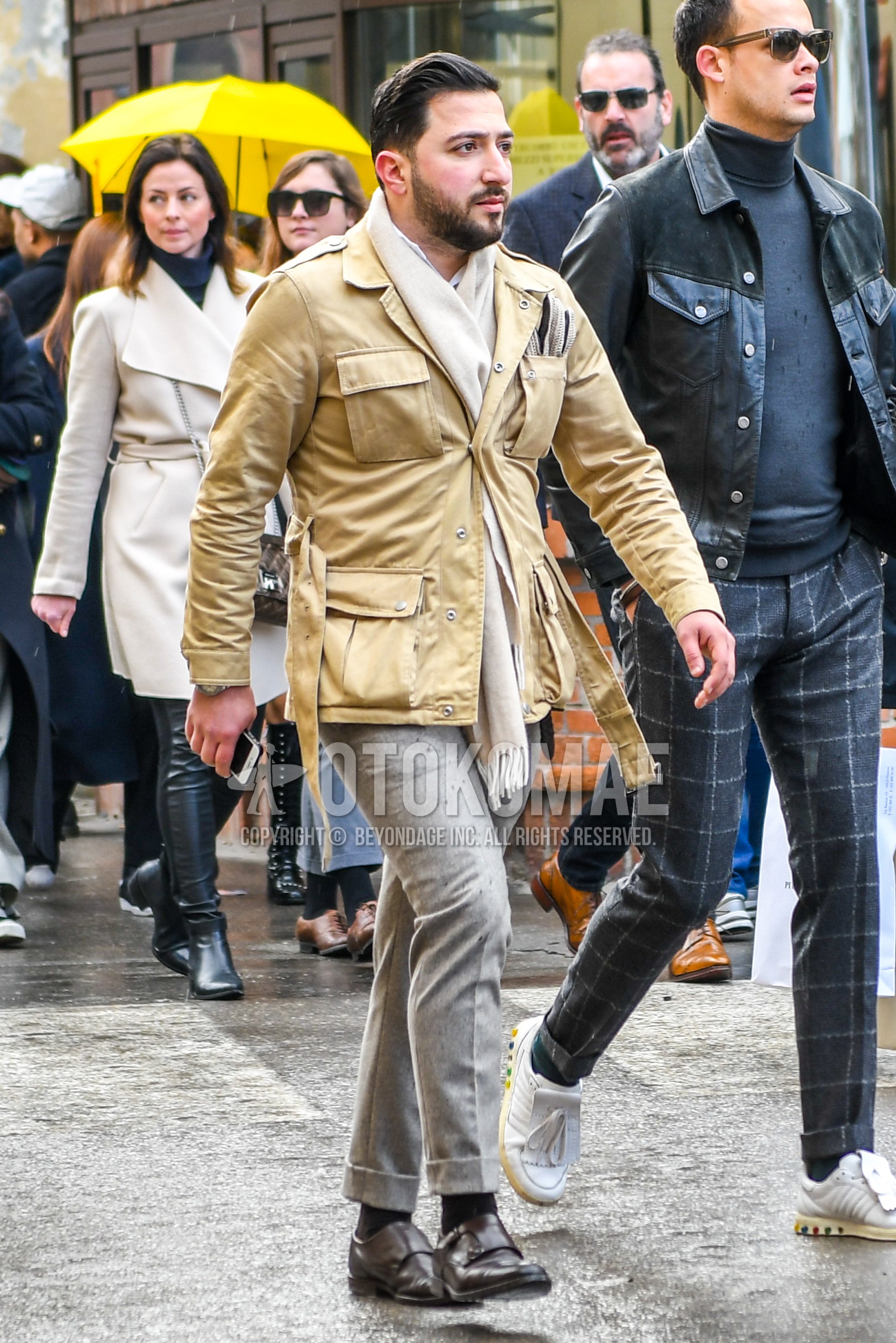 Men's winter outfit with beige plain scarf, yellow plain M-65, gray plain slacks, black plain socks, brown monk shoes leather shoes.