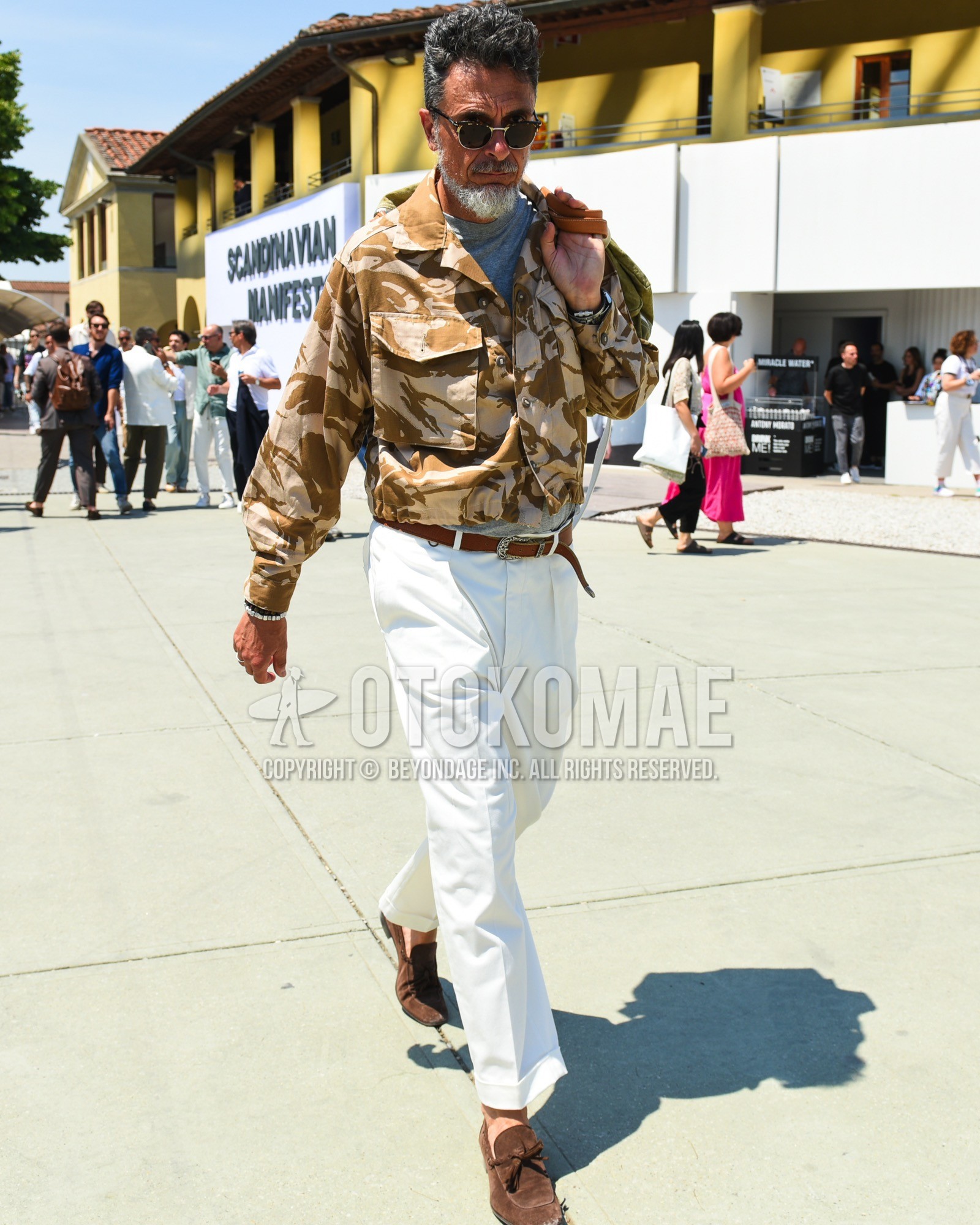 Men's spring summer outfit with brown tortoiseshell sunglasses, brown camouflage shirt jacket, gray plain t-shirt, brown plain leather belt, white plain slacks, brown tassel loafers leather shoes, brown suede shoes leather shoes.