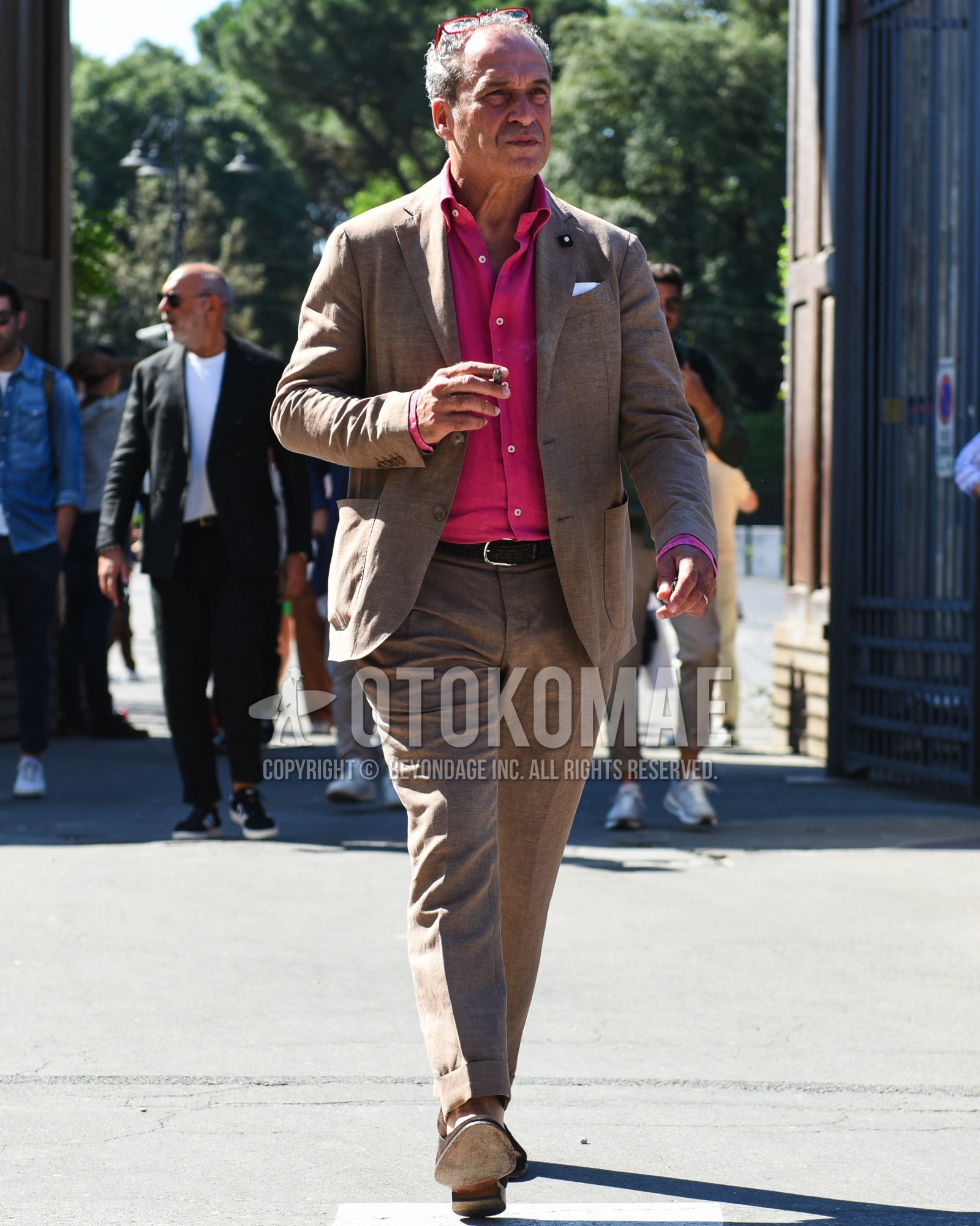 Men's spring summer outfit with red plain glasses, pink plain shirt, black plain leather belt, brown  loafers leather shoes, brown plain suit.
