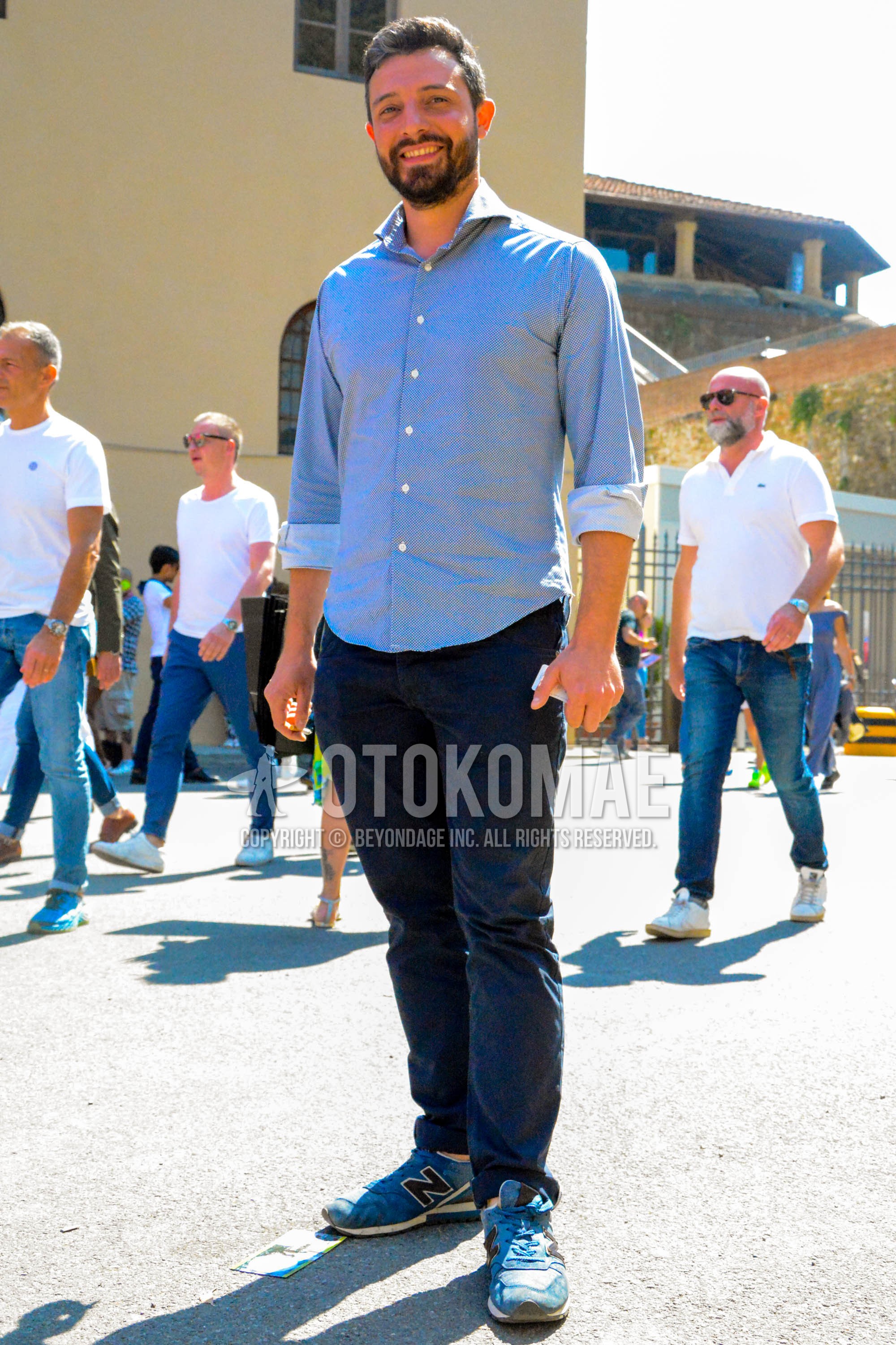 Men's spring summer outfit with blue tops/innerwear shirt, navy plain cotton pants, blue low-cut sneakers.