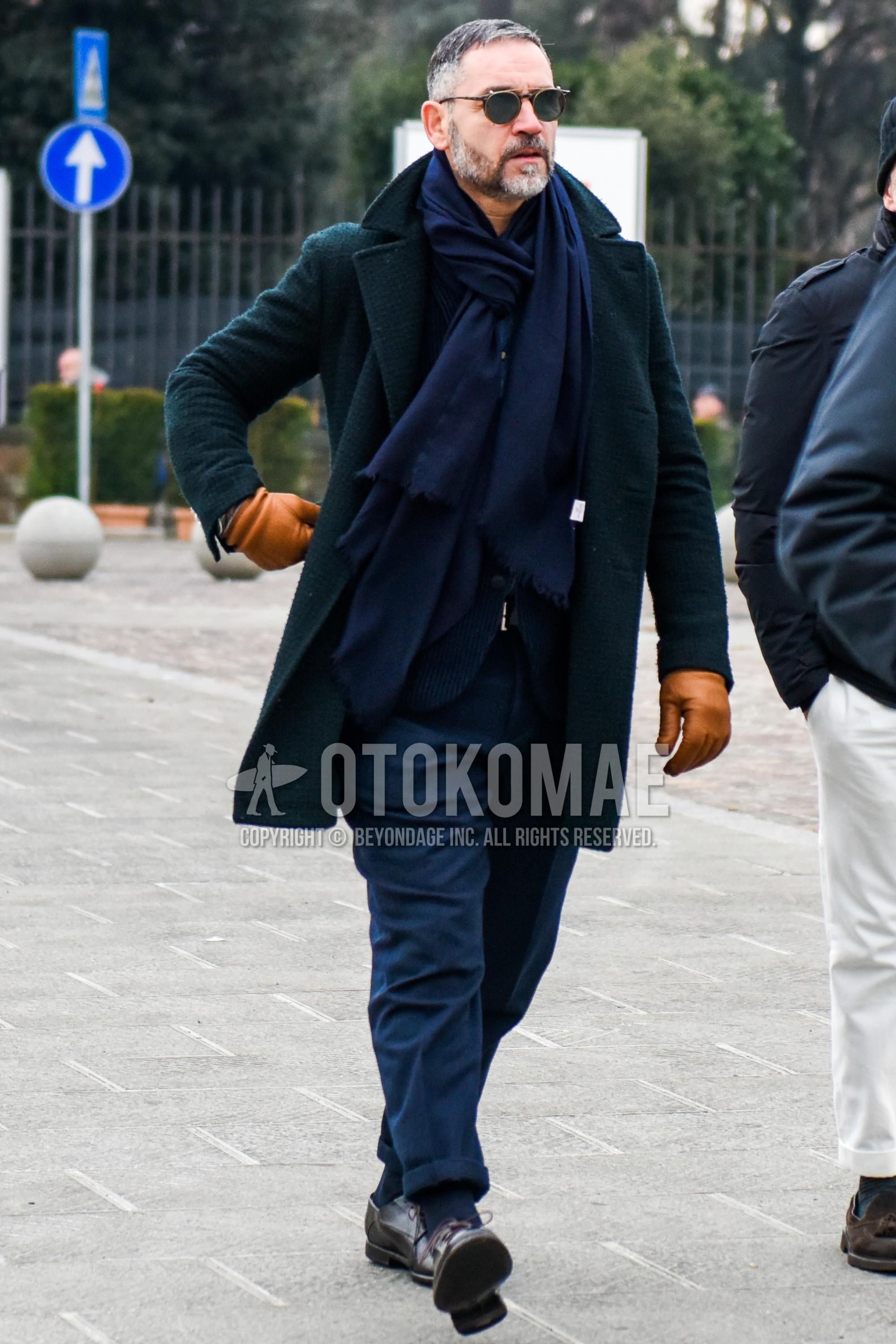 Men's autumn winter outfit with black plain sunglasses, navy plain scarf, green check ulster coat, navy stripes tailored jacket, navy plain bottoms, navy plain socks, brown plain toe leather shoes.