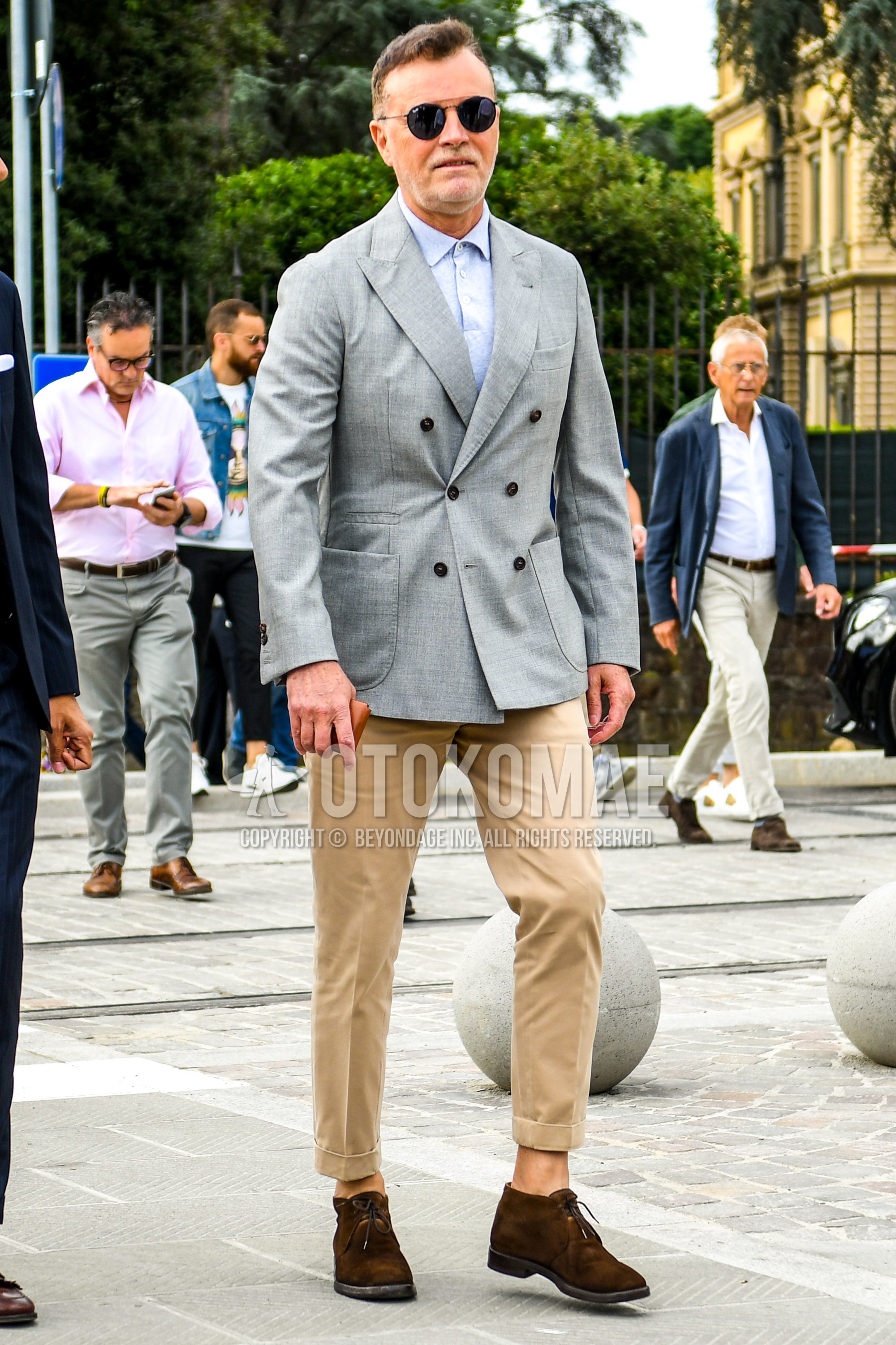 Men's spring summer autumn outfit with plain sunglasses, gray plain tailored jacket, light blue plain shirt, beige plain ankle pants, brown suede shoes leather shoes.
