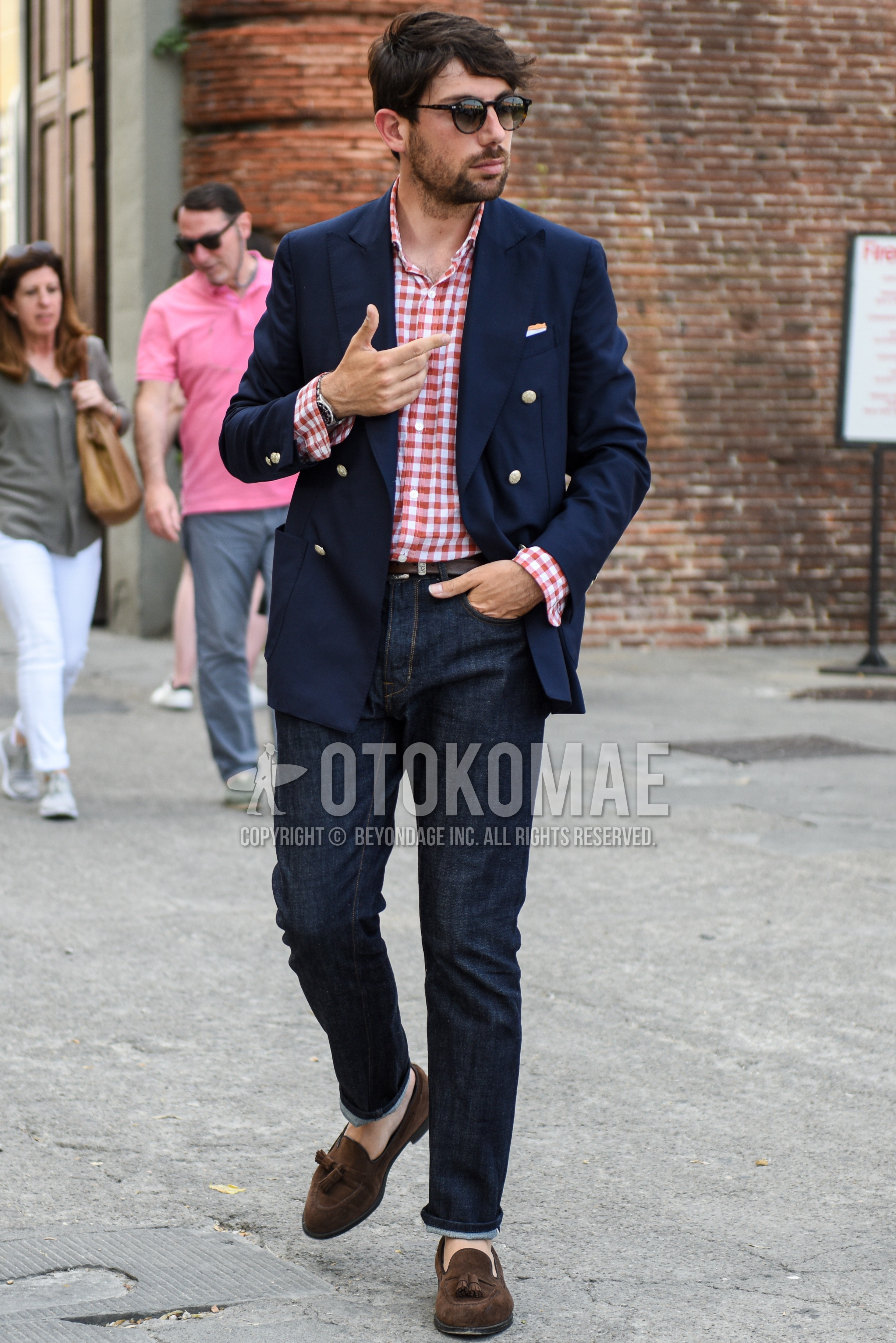 Men's spring summer autumn outfit with black plain sunglasses, navy plain tailored jacket, white red check shirt, brown plain leather belt, navy plain denim/jeans, brown tassel loafers leather shoes.