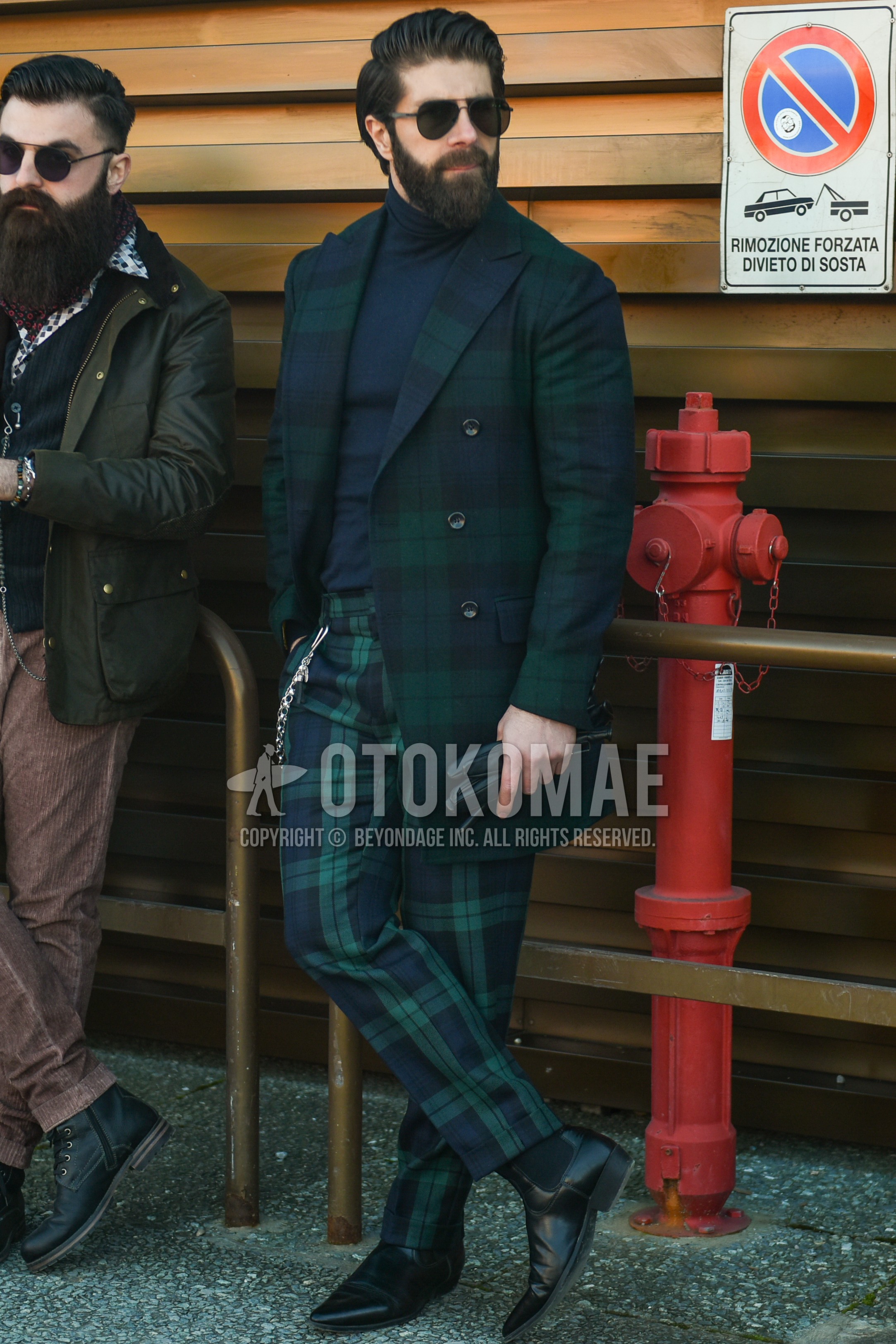 Men's autumn winter outfit with black plain sunglasses, olive green navy check chester coat, gray plain turtleneck knit, olive green navy check slacks, black side-gore boots.