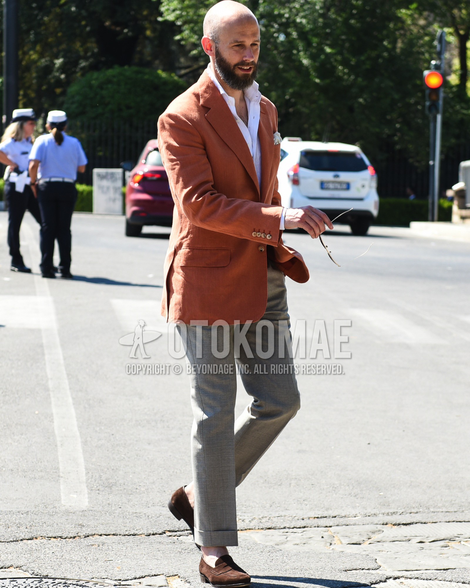 Men's spring summer outfit with orange plain tailored jacket, white plain shirt, plain slacks, brown coin loafers leather shoes, brown suede shoes leather shoes.